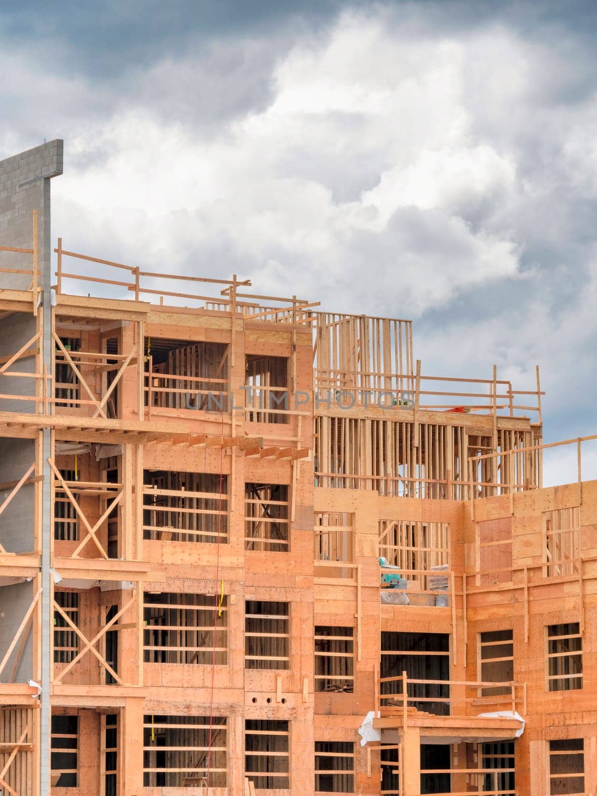 Apartment building under construction on cloudy sky background.