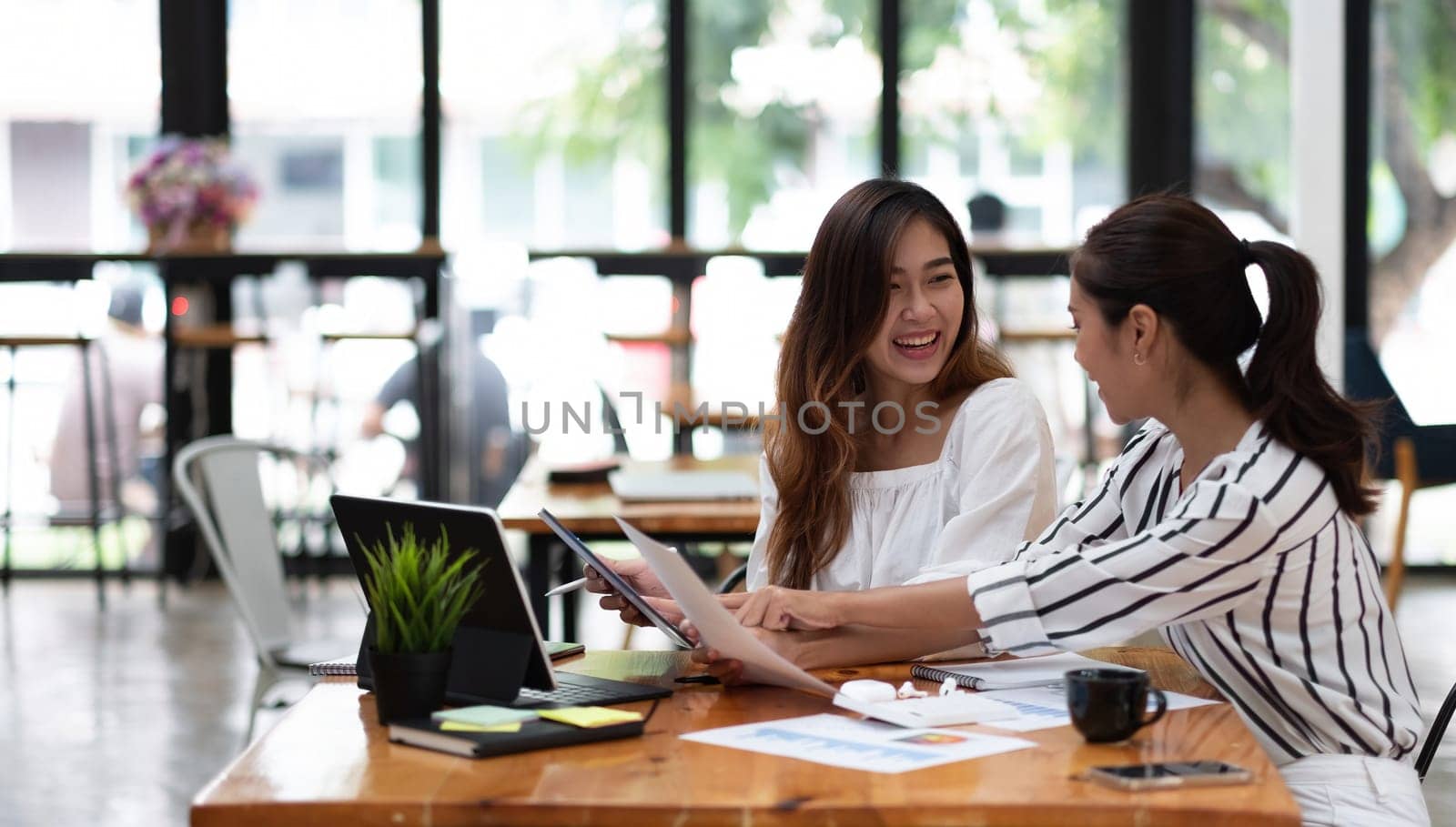 Two business woman young entrepreneur meeting talking about new project, startup business project concept