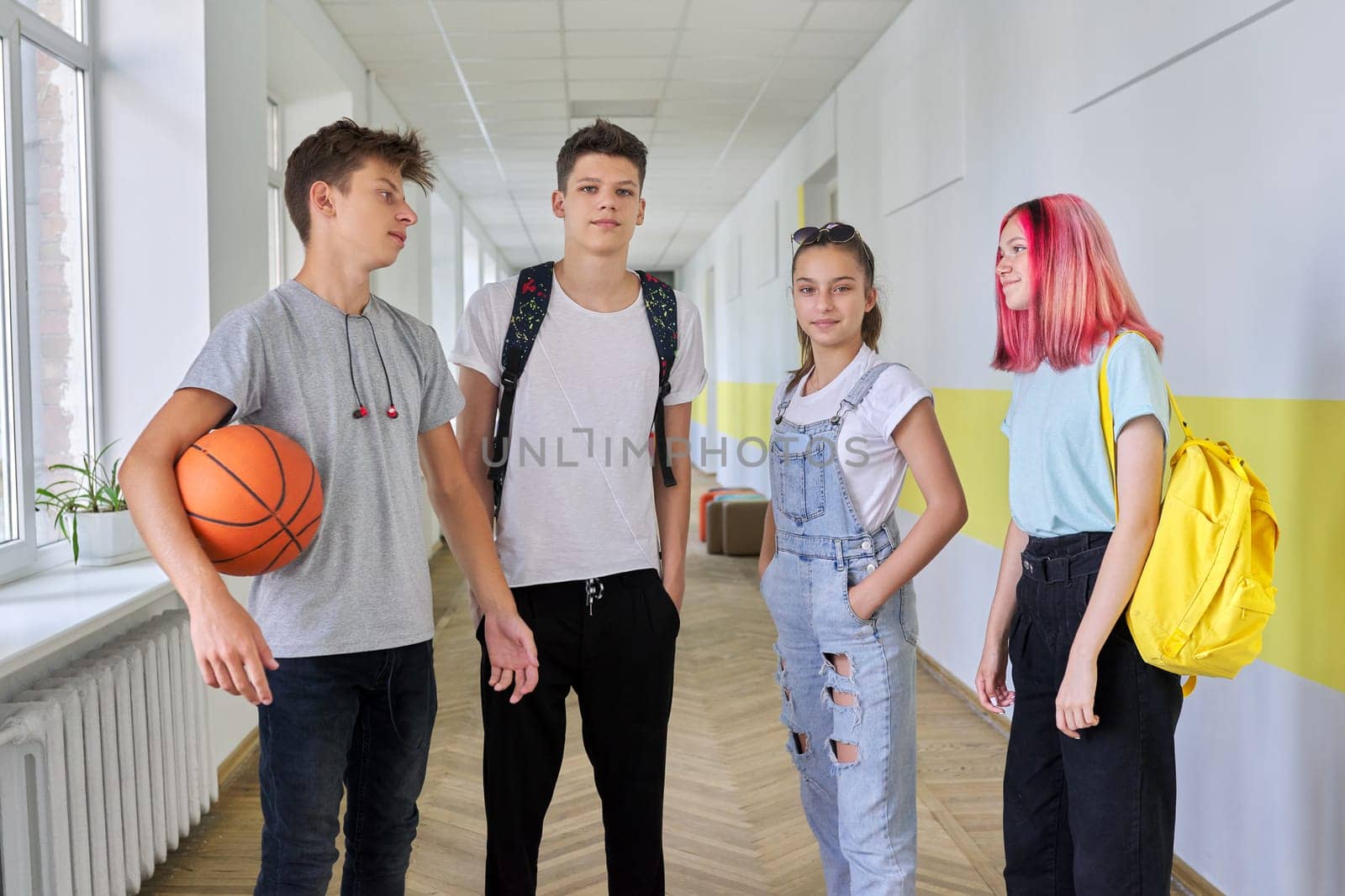 A group of teenage students 16 years old in the school hallway by VH-studio