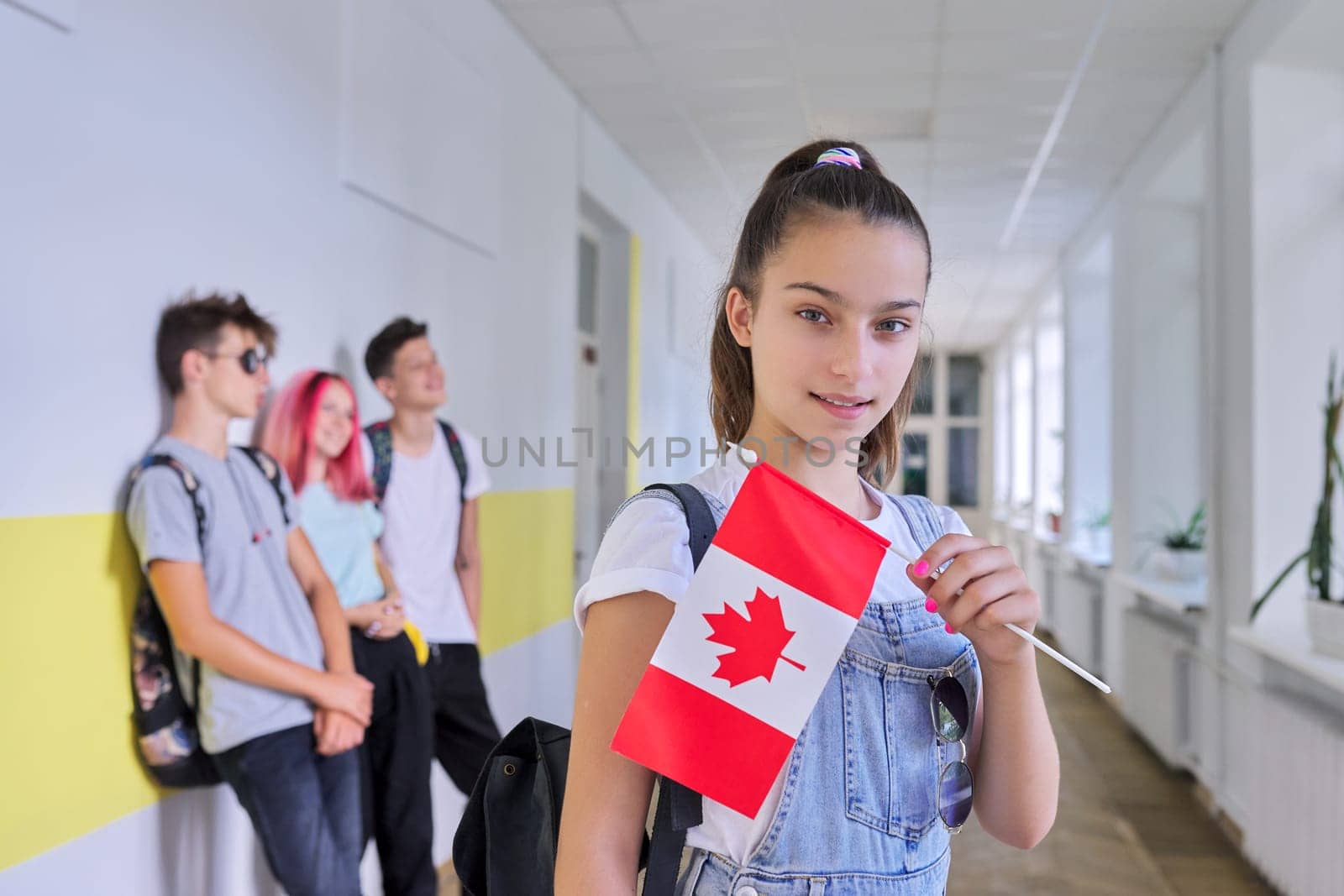 Student teenager female with flag of Canada inside school by VH-studio