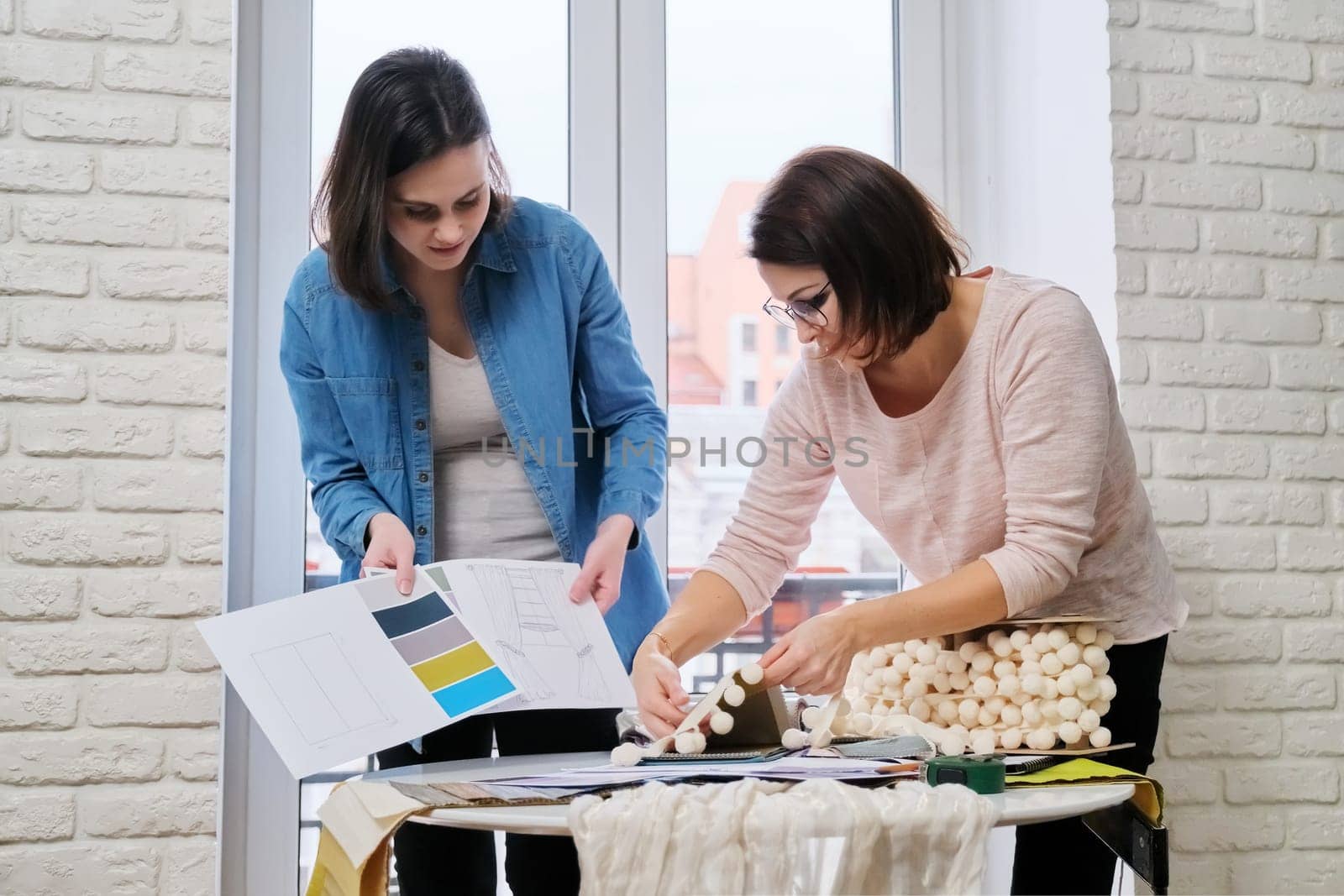 Interior design, working women designers choosing samples of fabrics by VH-studio