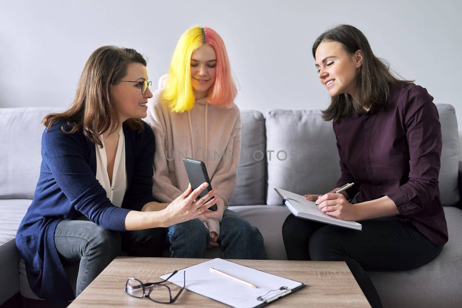 Social worker, psychologist, counselor at meeting with mature woman and her teenage daughter. Psychology, family mental health, adolescence problems, mother daughter child parent relationships