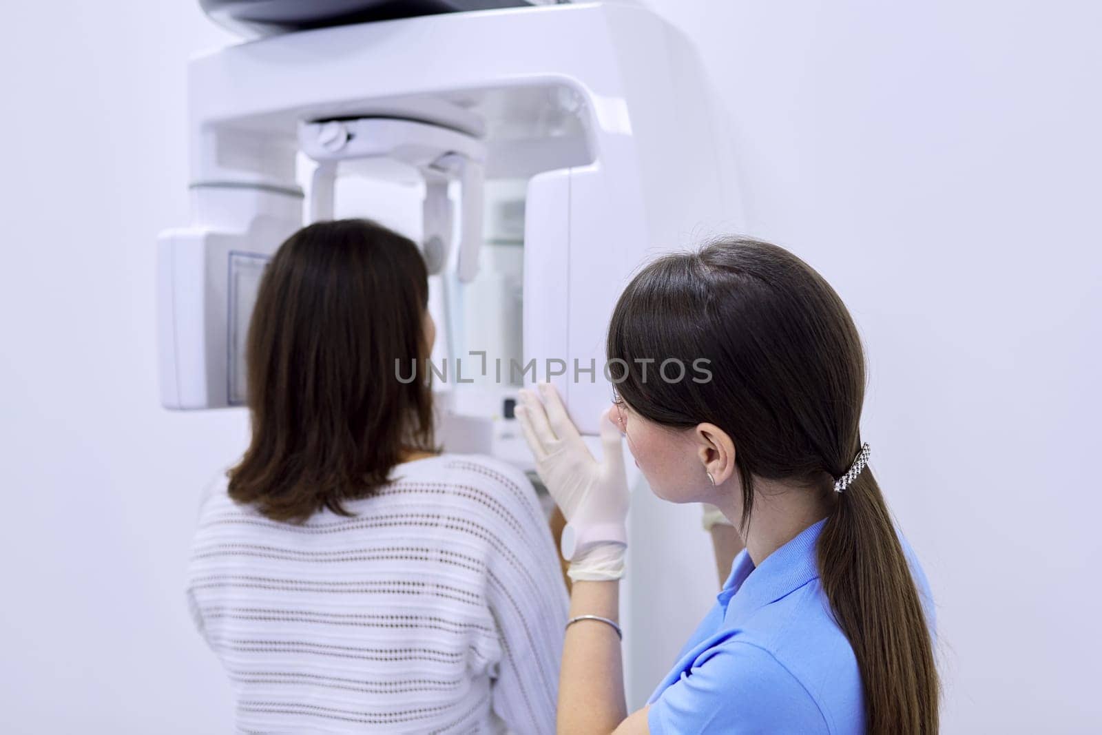 Dental diagnostic examination, dental x-ray equipment, nurse with woman patient. Panoramic radiography, medical technology