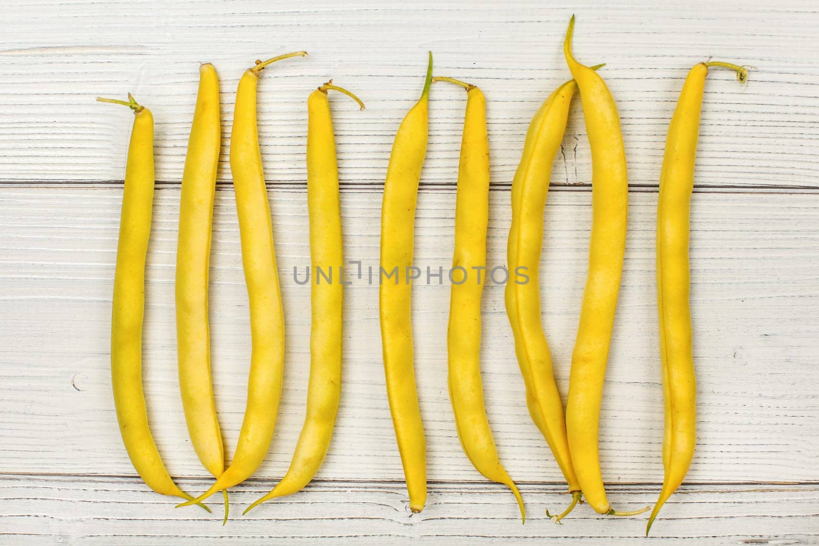 Tabletop view - yellow string (wax) beans on white boards. 