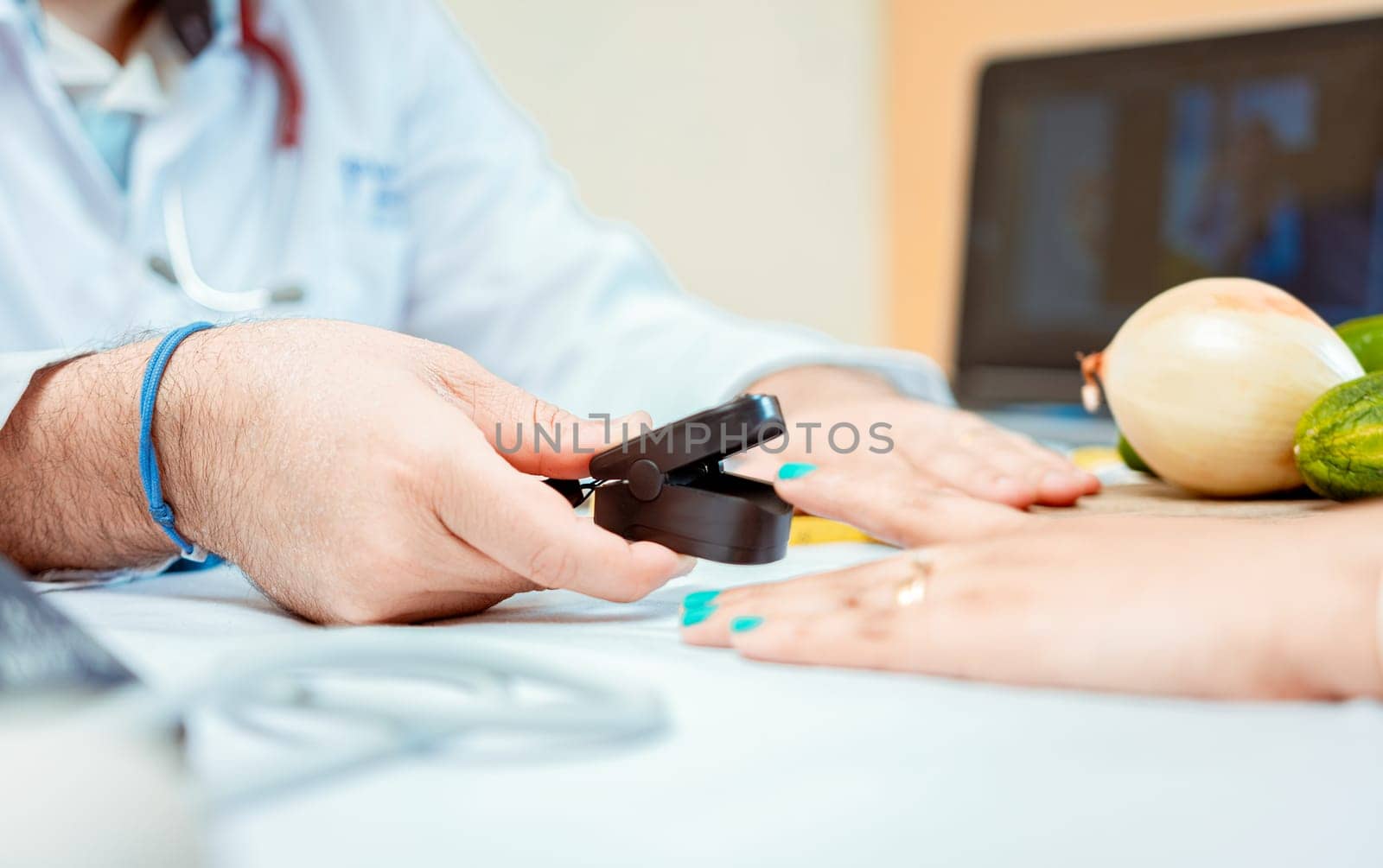 Hand of nutritionist using oximeter on finger of female patient. Close up of hands of nutritionist using pulse oximeter on patient finger.  Nutritionist measuring oxygen pulse to patient