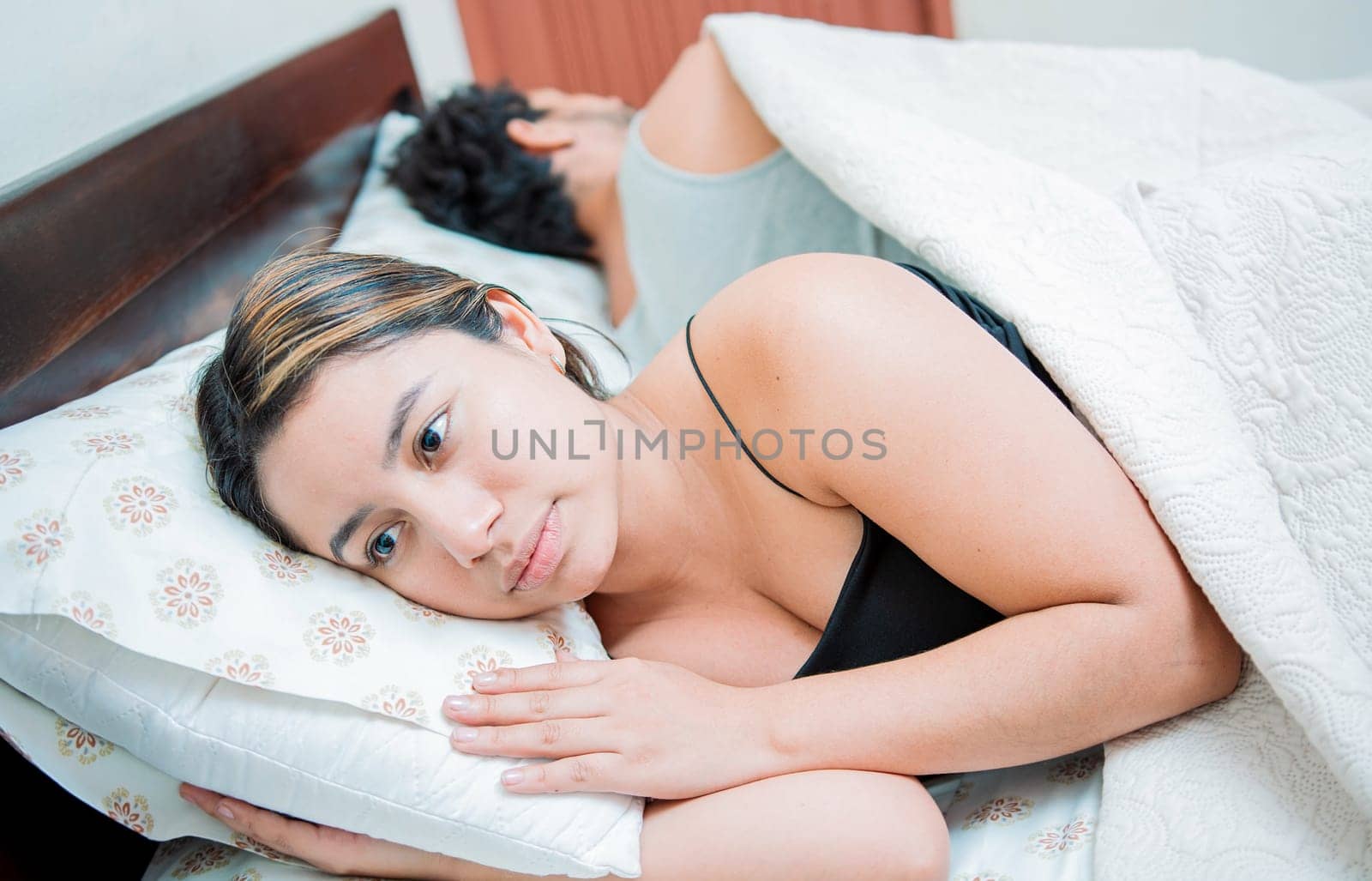 Young couple arguing and sleeping apart. Concept of couple problems in bed. Unhappy couple in bed sleeping apart, Upset couple sleeping on their backs