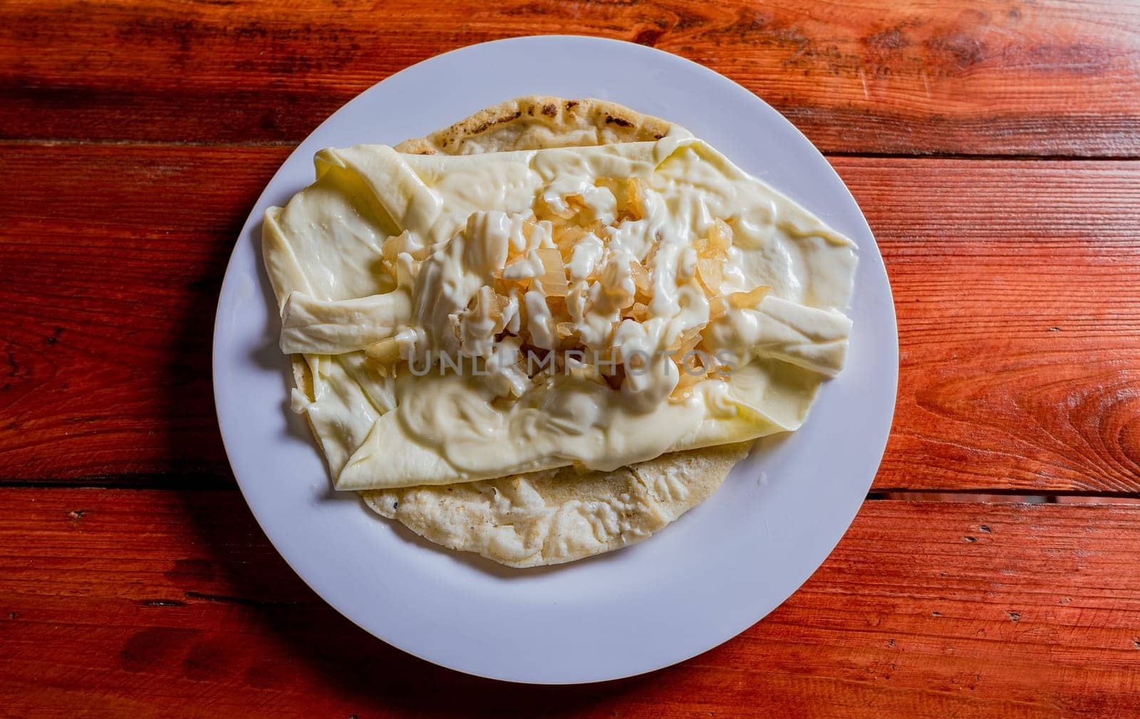 Top View of traditional Cheese with Pickled Onion, Traditional cheese dish with pickled onion and cream. Concept of typical foods of latin america