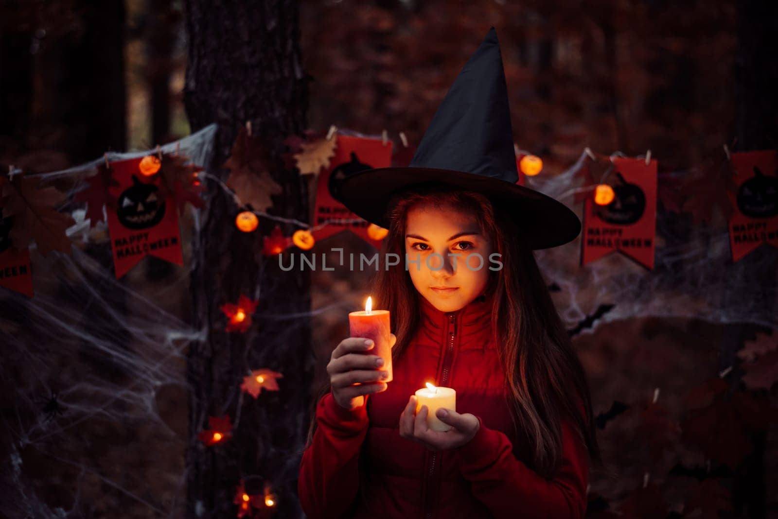 Little child girl with burning candles in dark forest by VitaliiPetrushenko