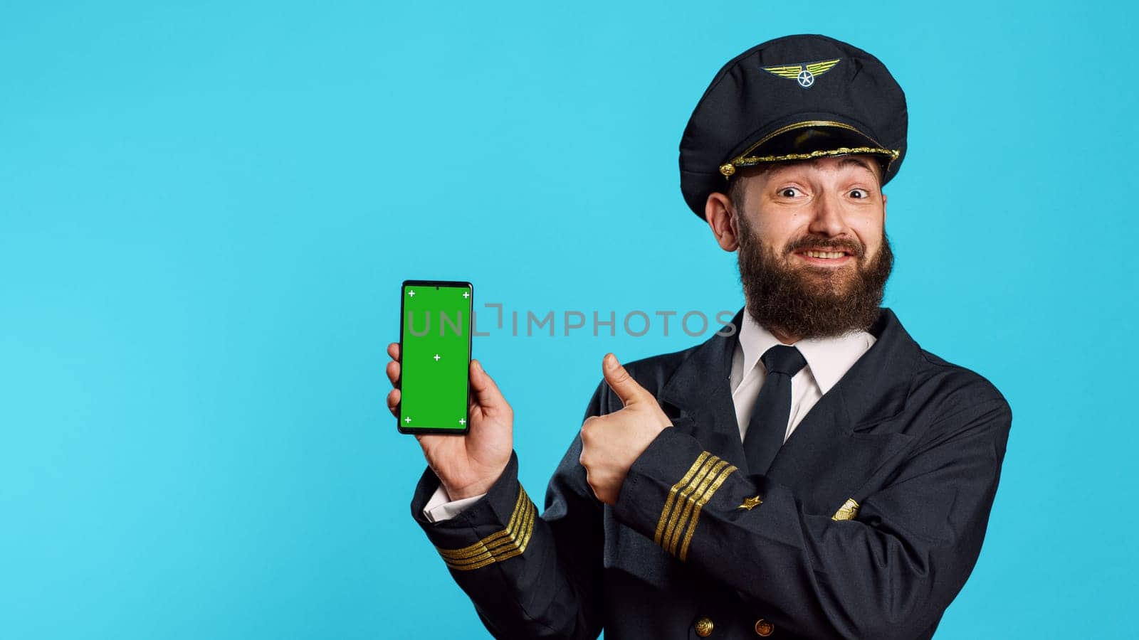 Smiling male aviator using telephone with greenscreen by DCStudio