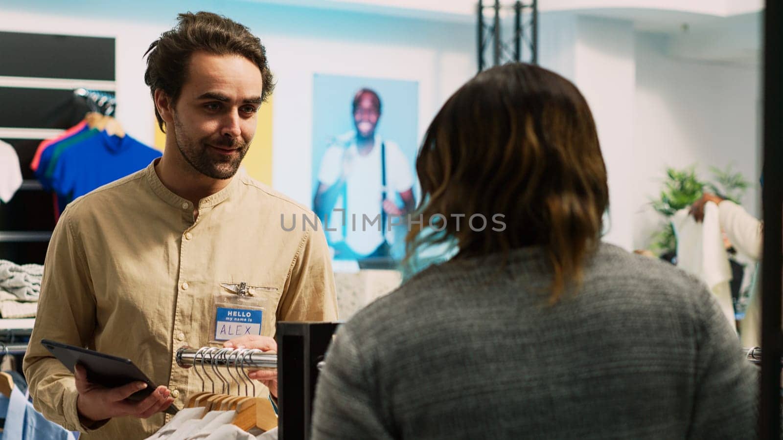 Store assistant doing inventory near boutique aisles by DCStudio