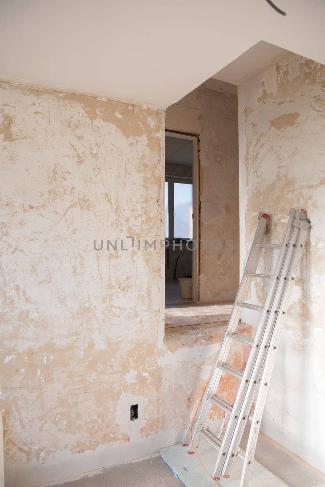 an empty room in an apartment with peeling walls in need of a major overhaul. High quality photo