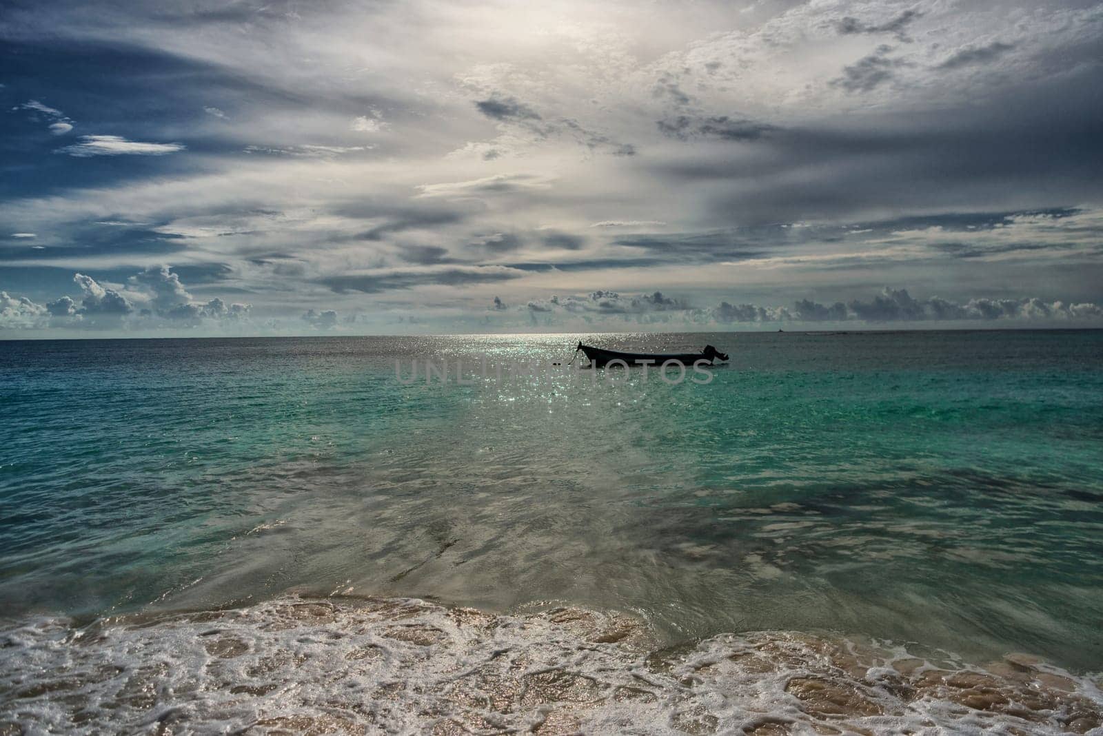 The boat in the Caribbean Sea on a sunny day. Clear water.