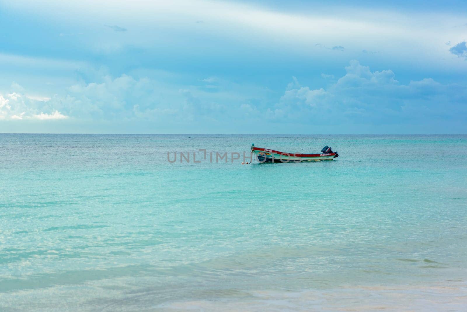 The boat in the Caribbean Sea on a sunny day. Clear water.