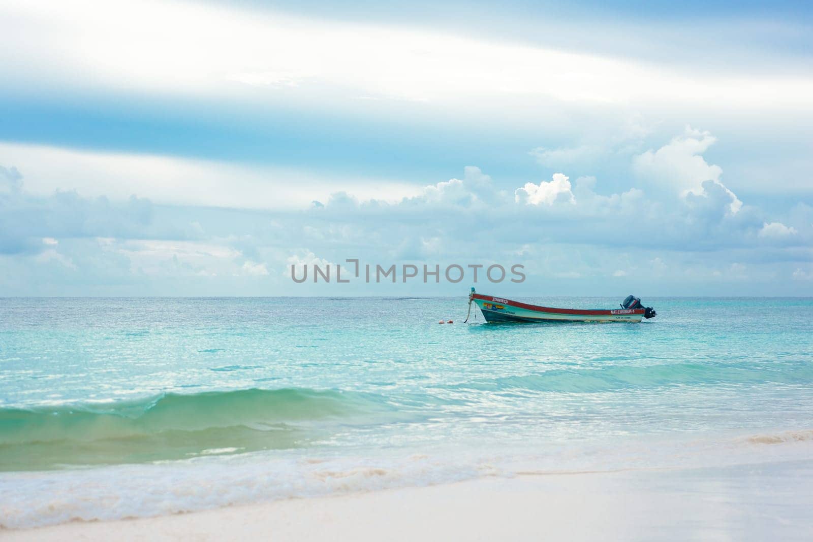 The boat in the Caribbean Sea on a sunny day. Clear water.