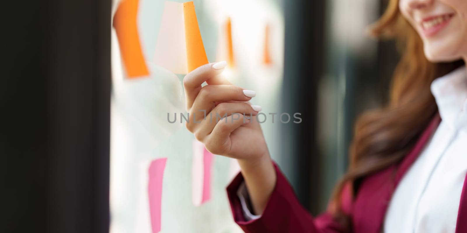 Beautiful asian business woman working with sticky note at office. Financial analysis and tax concept.