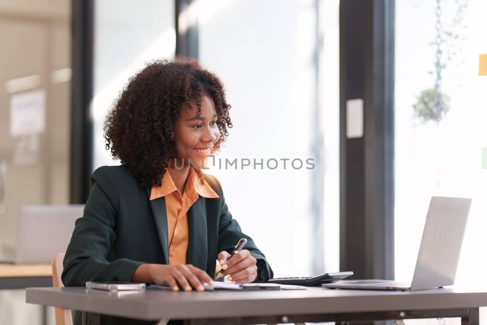 Accountant black woman working on laptop and do document, tax, exchange, accounting and Financial advisor concept by itchaznong