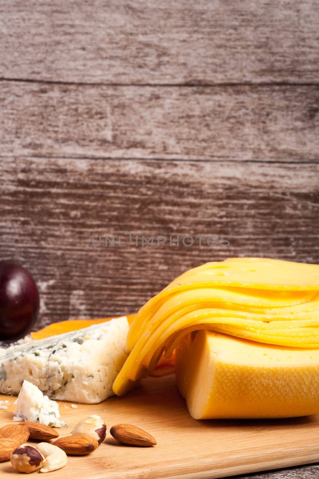 Gourmet cheese apetizer on wooden background by DCStudio