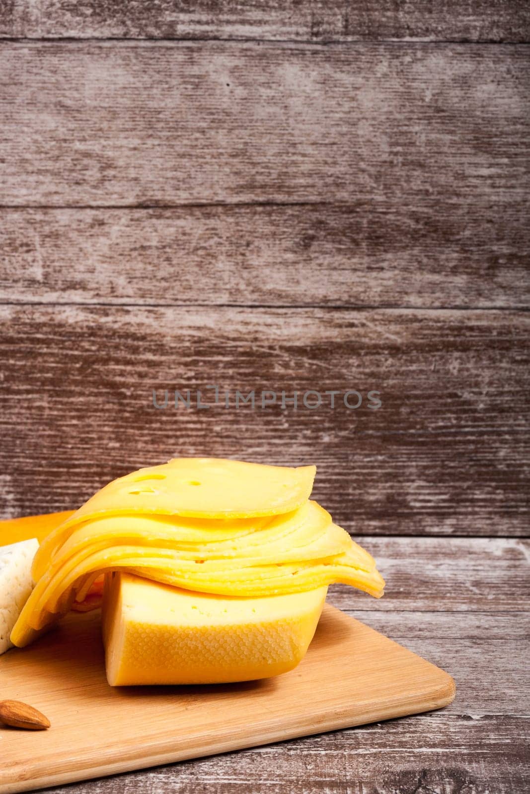 Gourmet cheese apetizer on wooden background. Delicatessen snack