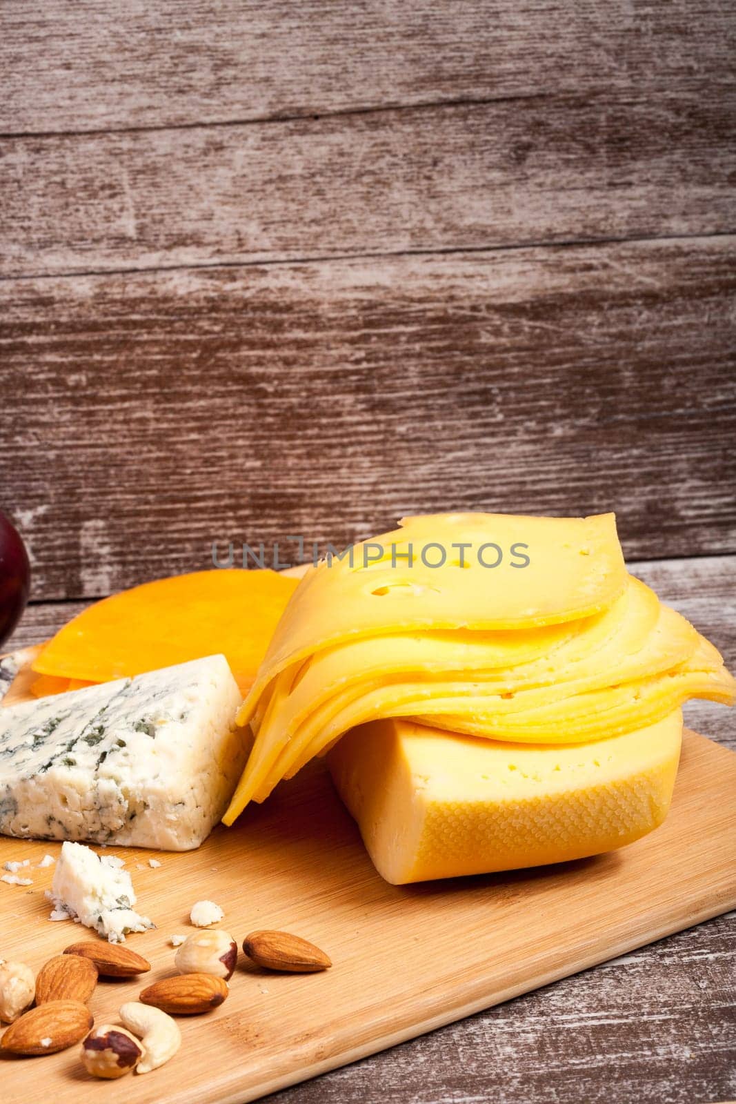 Gourmet cheese apetizer on wooden background. Delicatessen snack