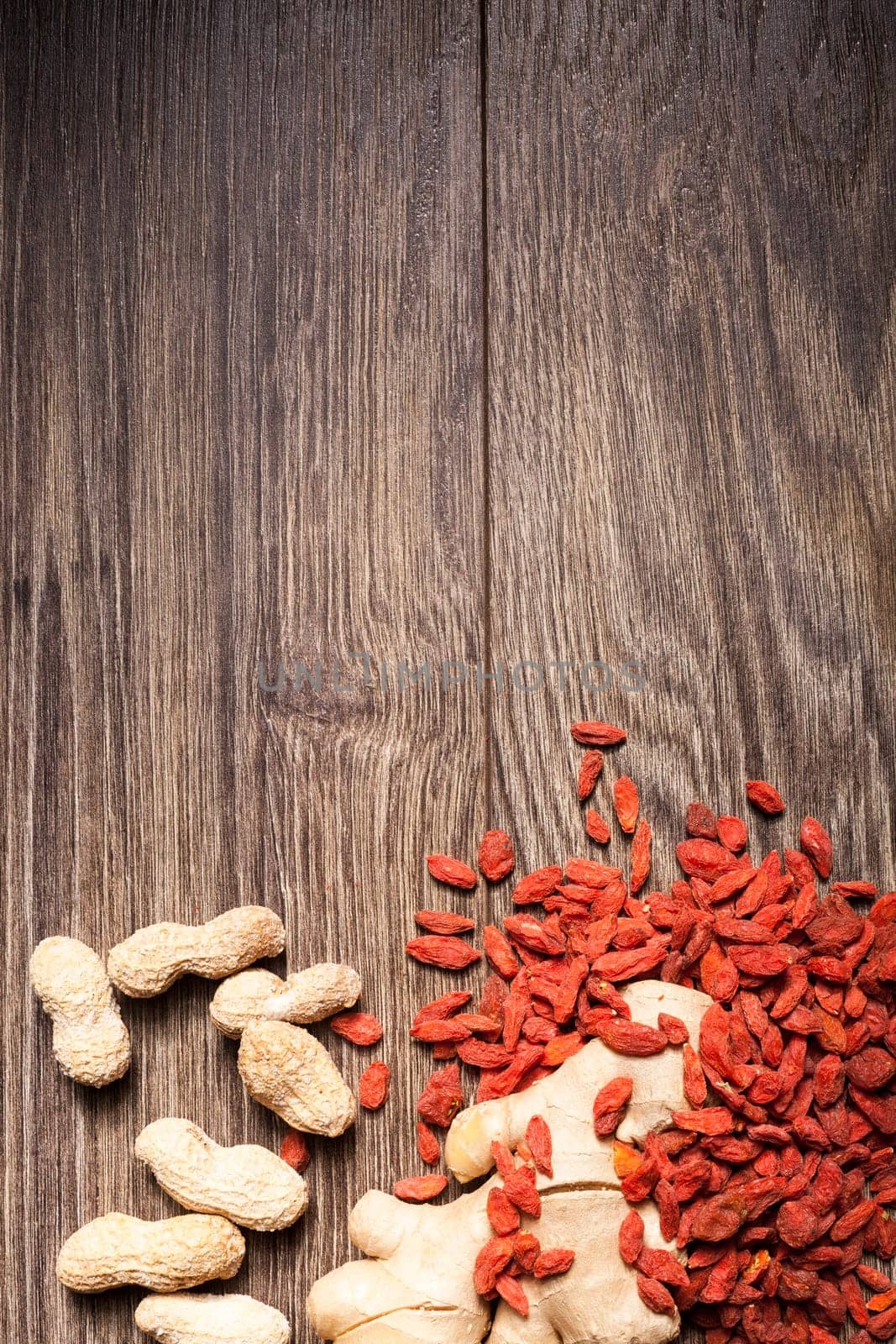 Raw organic food and nuts on wooden background. Over top view
