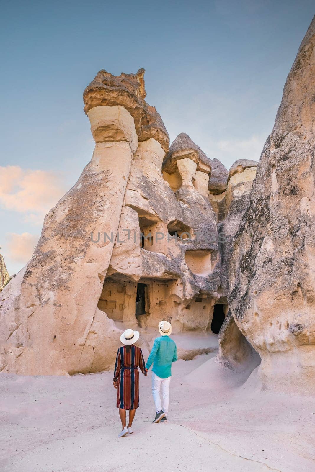 happy young couple on vacation in Turkey Cappadocia, Rock Formations in Pasabag Monks Valley, Cappadocia, Turkey by fokkebok