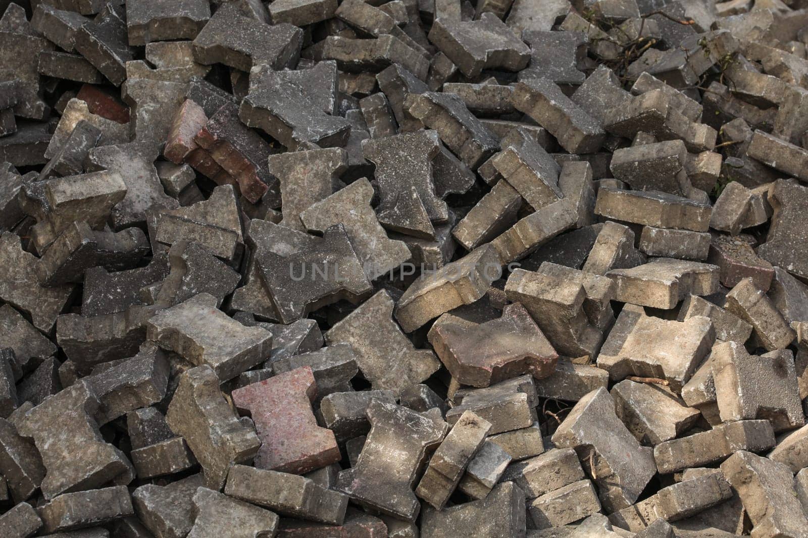 Pile of discarded pavement (segmental paver) cobblestones.