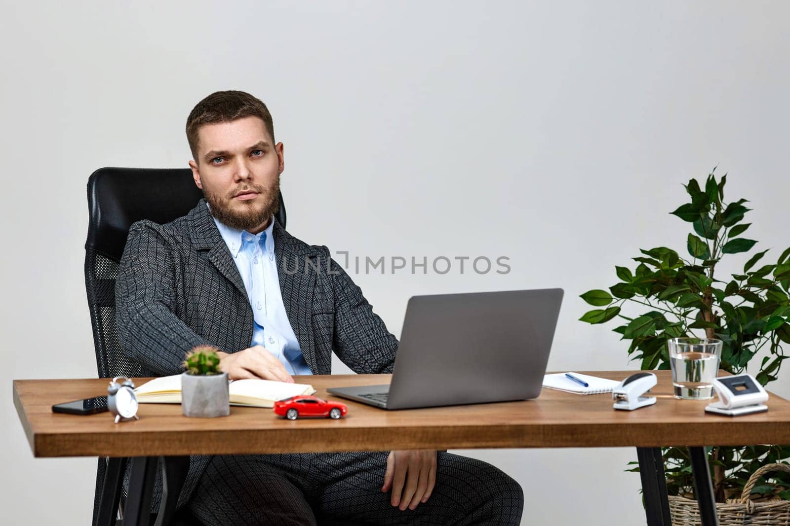 young man sitting on chair at table and resting, using laptop