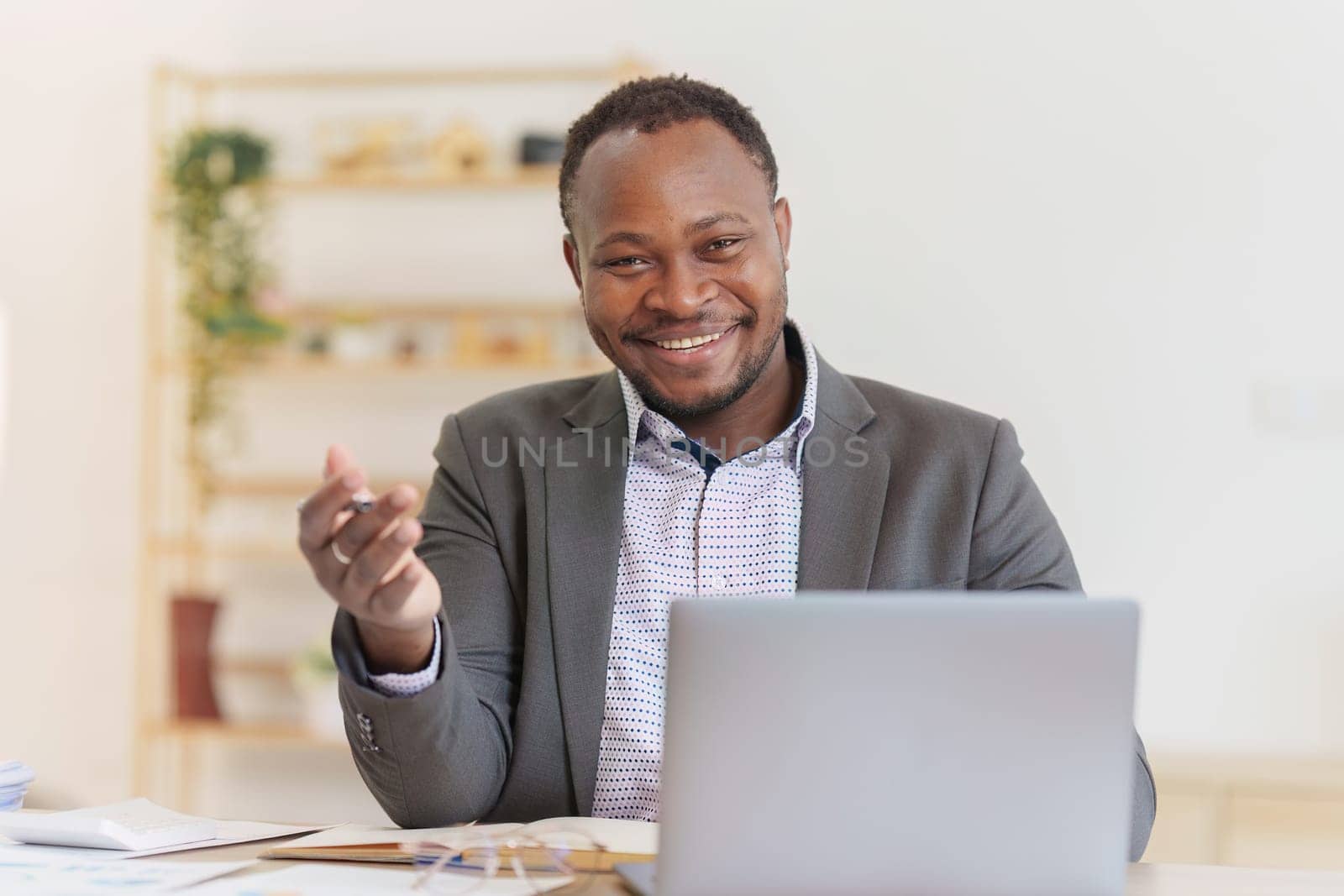 Smiling American African Banker or Accountant makes financial report and studies annual figures, analyzes profits. Accountant checks status of financial by itchaznong