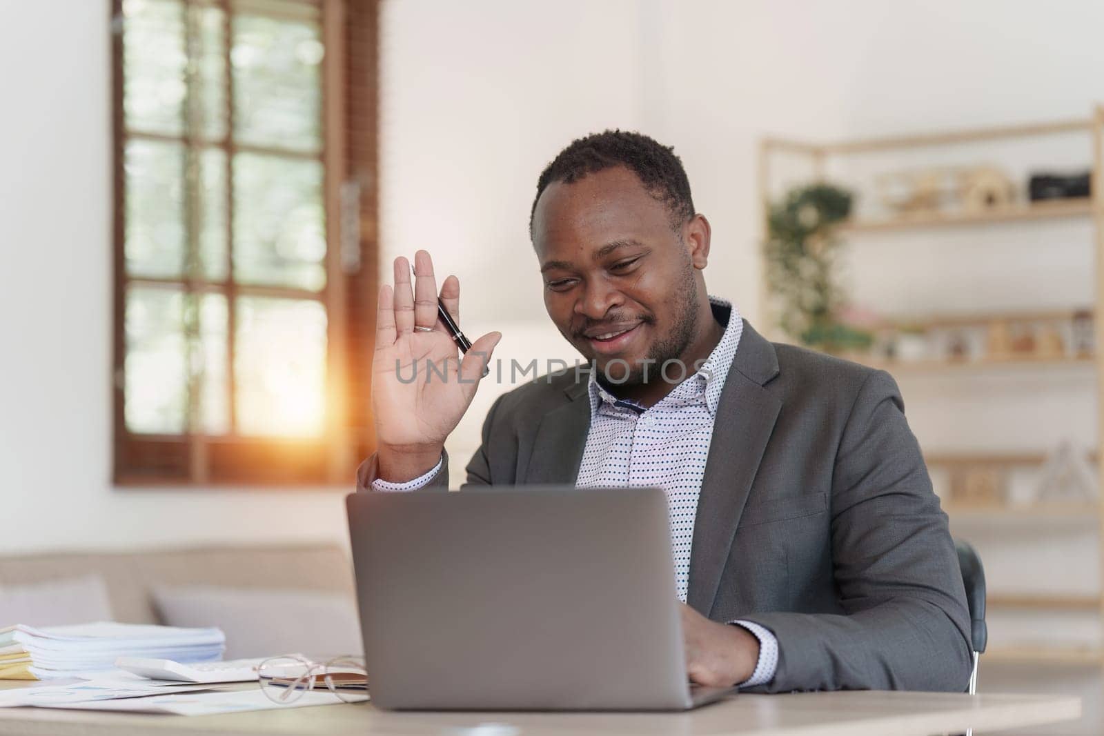 Smiling American African Banker or Accountant video call with client and makes financial report and studies annual figures, analyzes profits by itchaznong