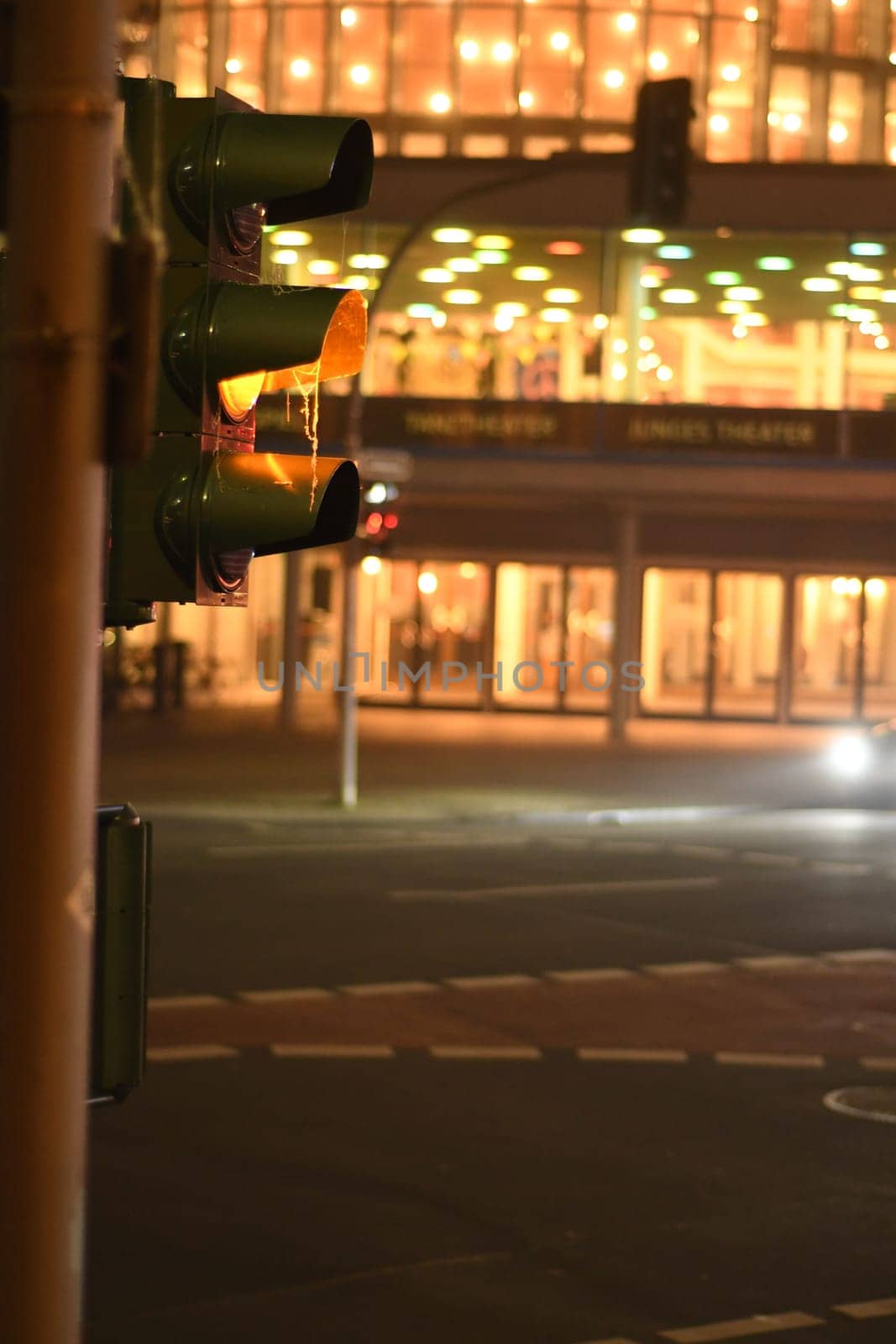 Vertical shot of a red traffic lights at night in Muenster, Germany