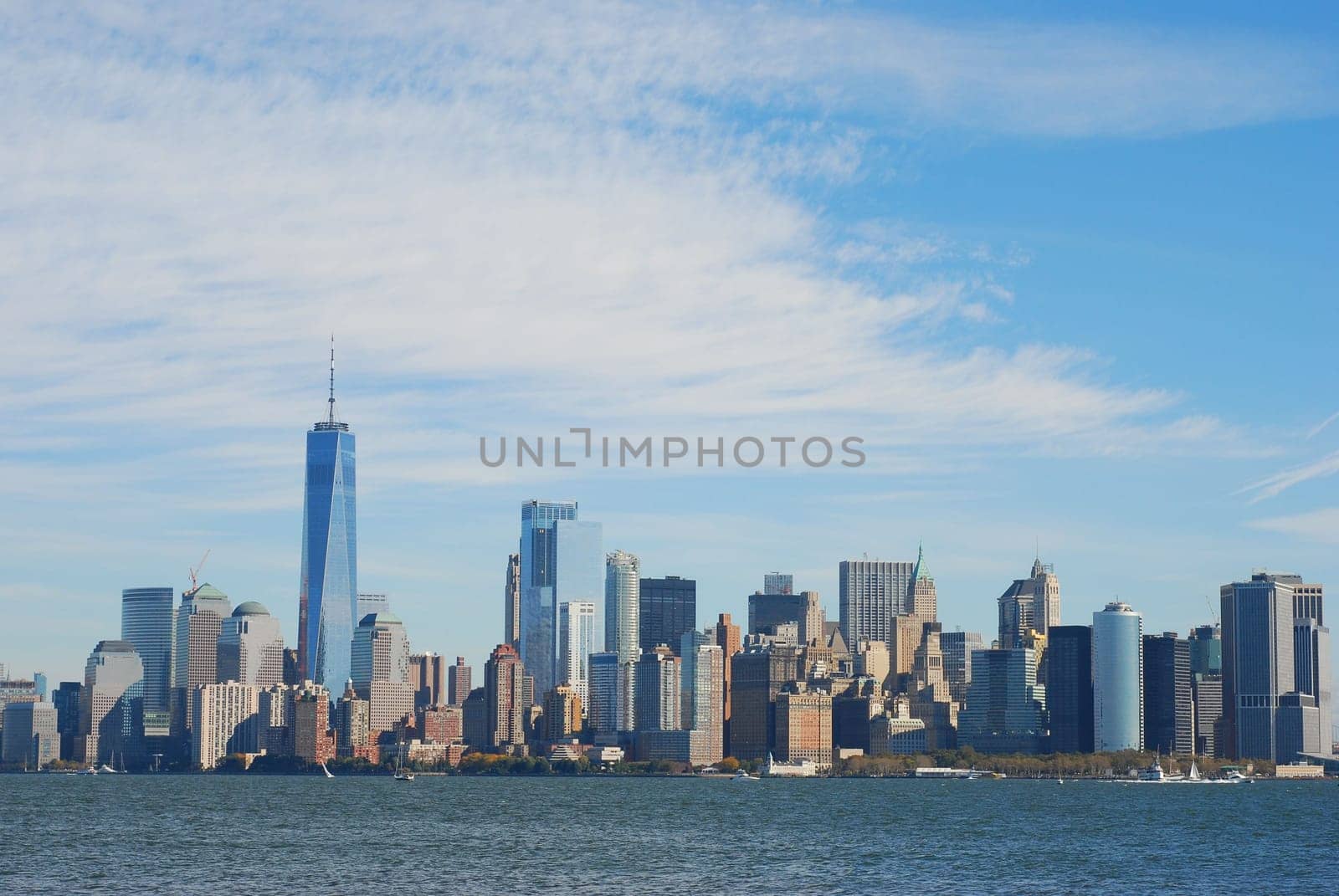 Gorgeous view of the Manhattan skyline with the Freedom Tower over a calm sea on a sunny day