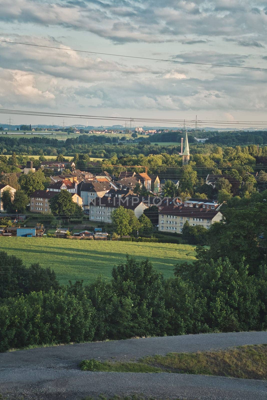 Scenic vertical shot of beautiful colliery houses surrounded with evergreen trees in Ruhr area, Germany