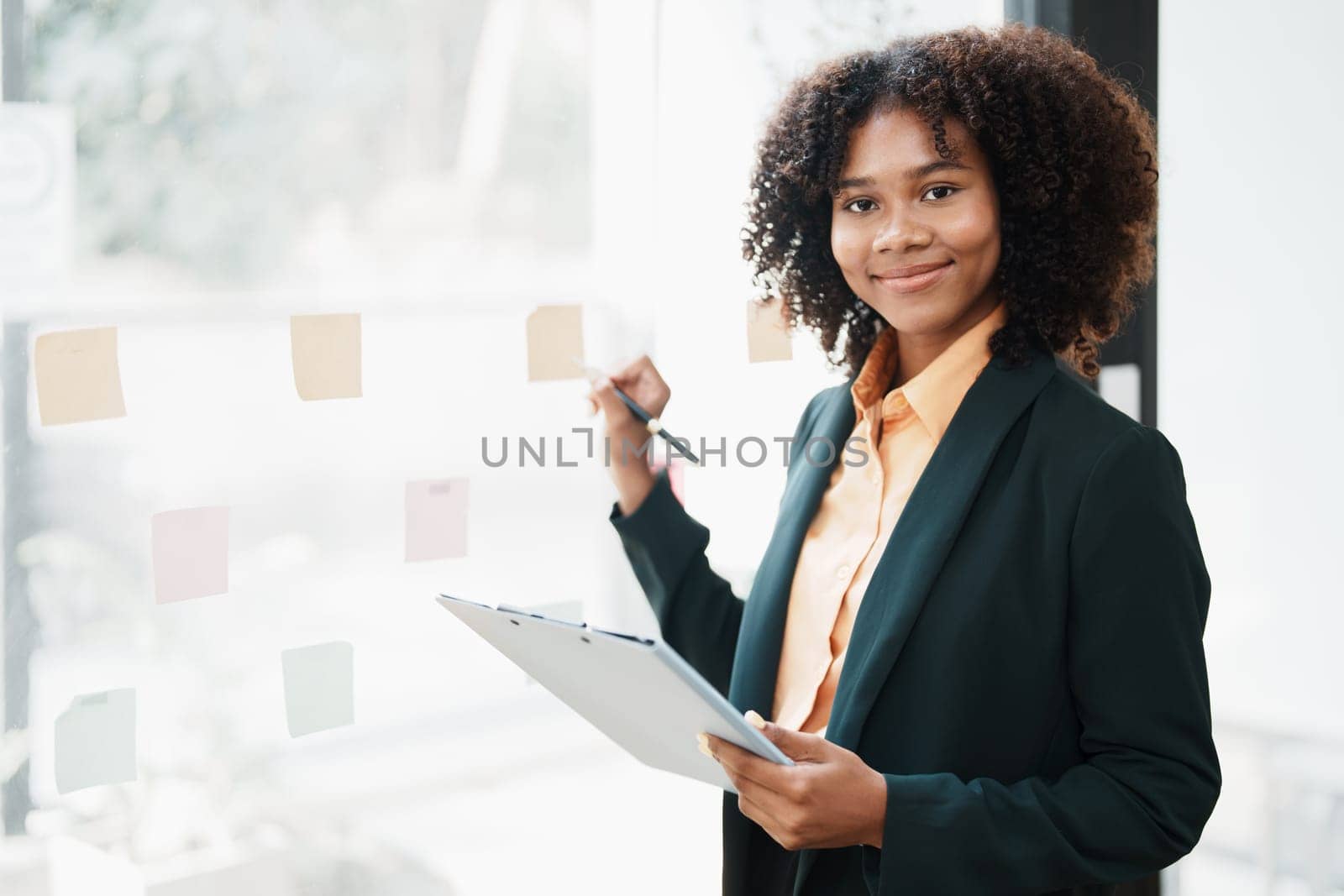 Beautiful young teen American African holding pen to note with planning working on financial document, tax, exchange, accounting and Financial advisor.