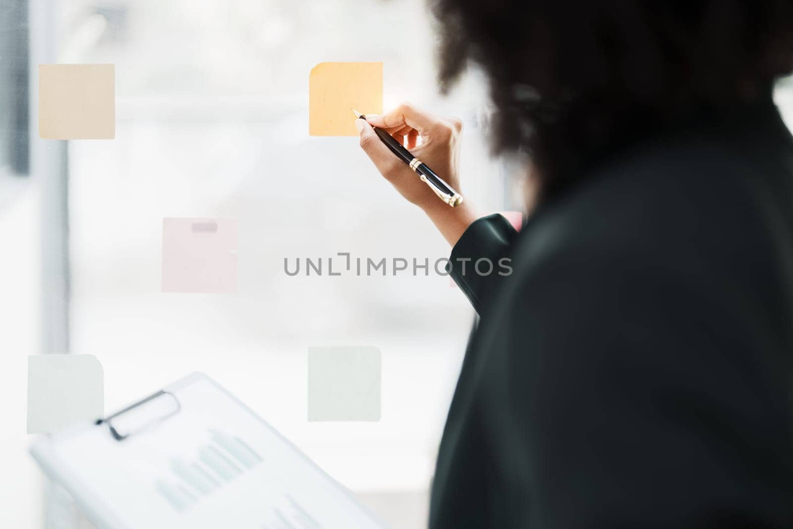 Beautiful young teen American African holding pen to note with planning working on financial document, tax, exchange, accounting and Financial advisor.