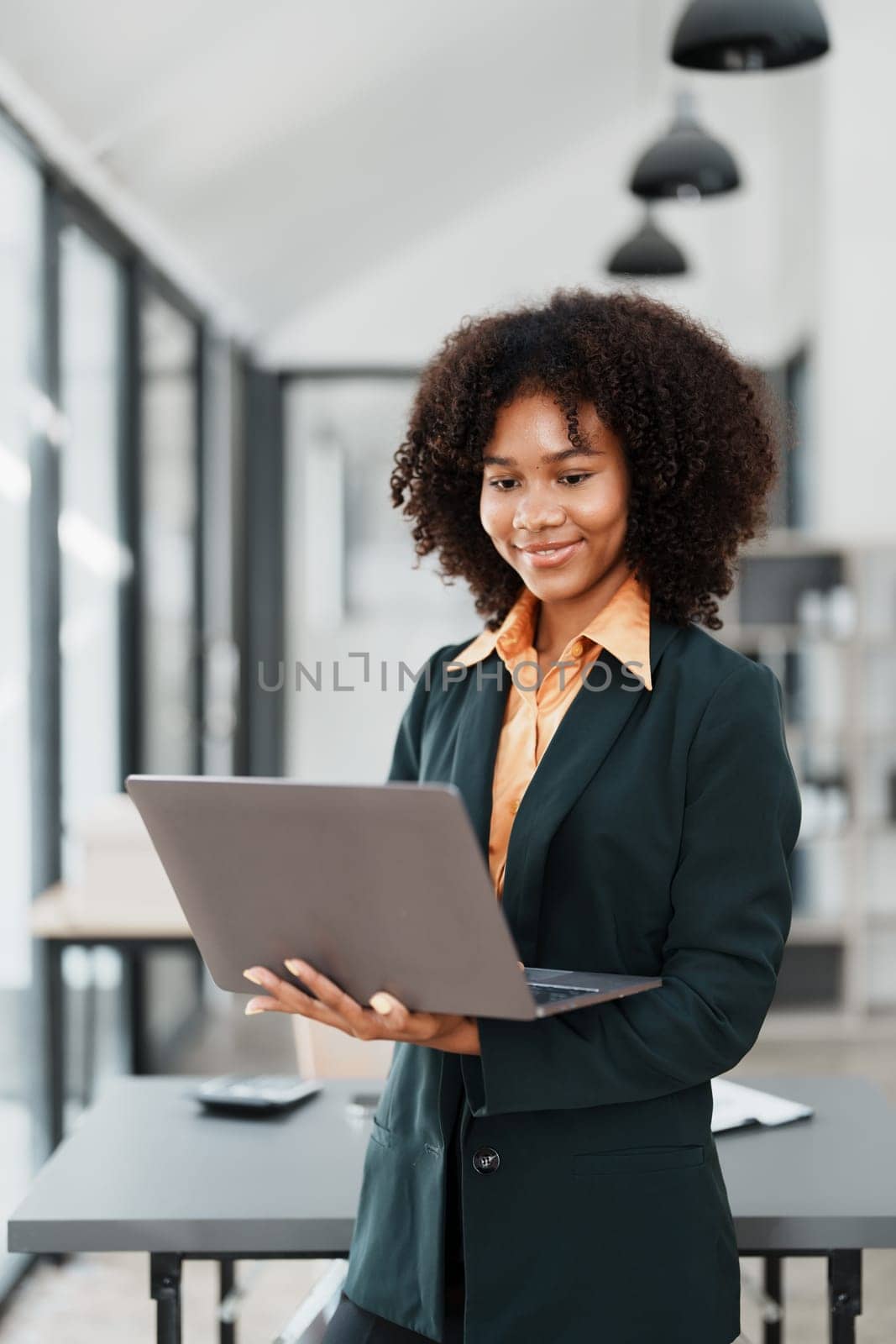 Beautiful young teen American African holding computer laptop with planning working on financial document, tax, exchange, accounting and Financial advisor.