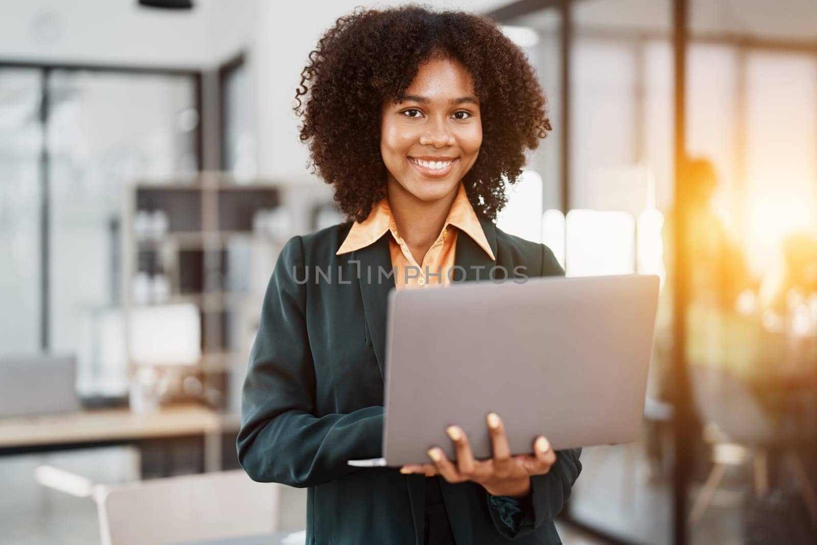 Beautiful young teen American African holding computer laptop with planning working on financial document, tax, exchange, accounting and Financial advisor.
