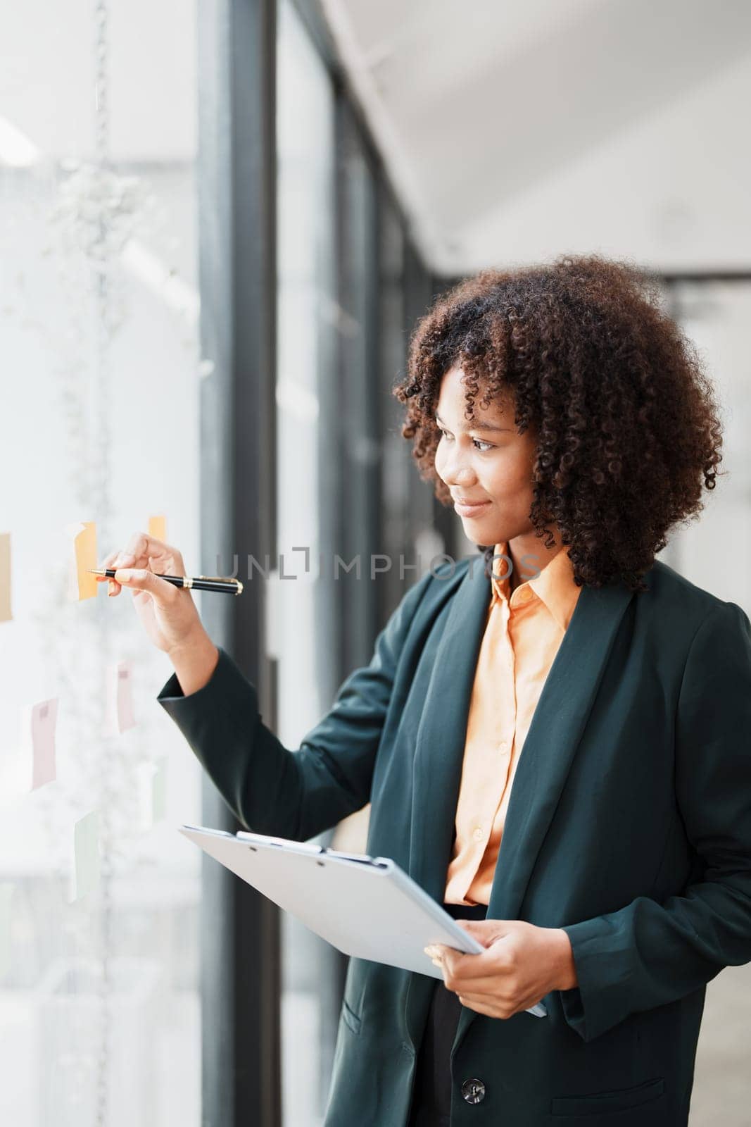 Beautiful young teen American African holding pen to note with planning working on financial document, tax, exchange, accounting and Financial advisor.