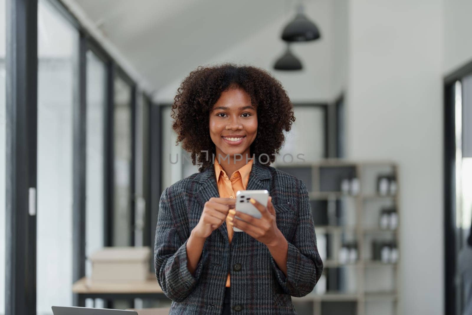 Beautiful young teen American African working on smartphone mobile with in do document, tax, exchange, accounting and Financial advisor.