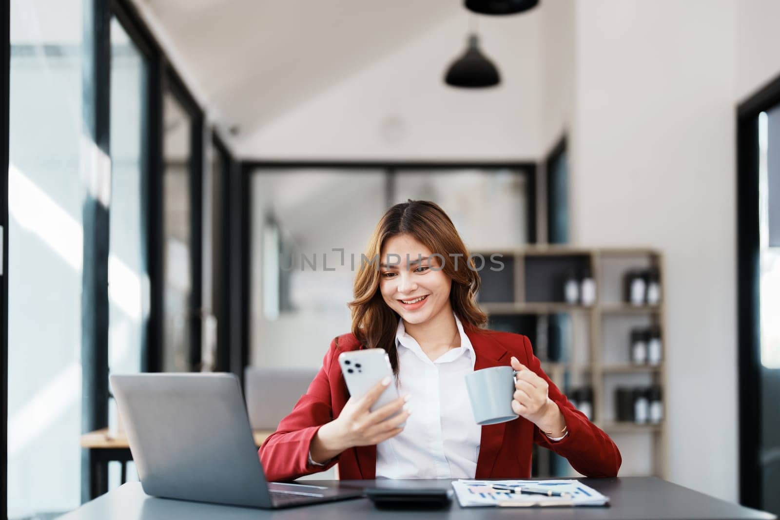 Beautiful young teen asian businesswoman using computer and smartphone mobile with planning working on financial document, tax, exchange, accounting and Financial advisor by Manastrong