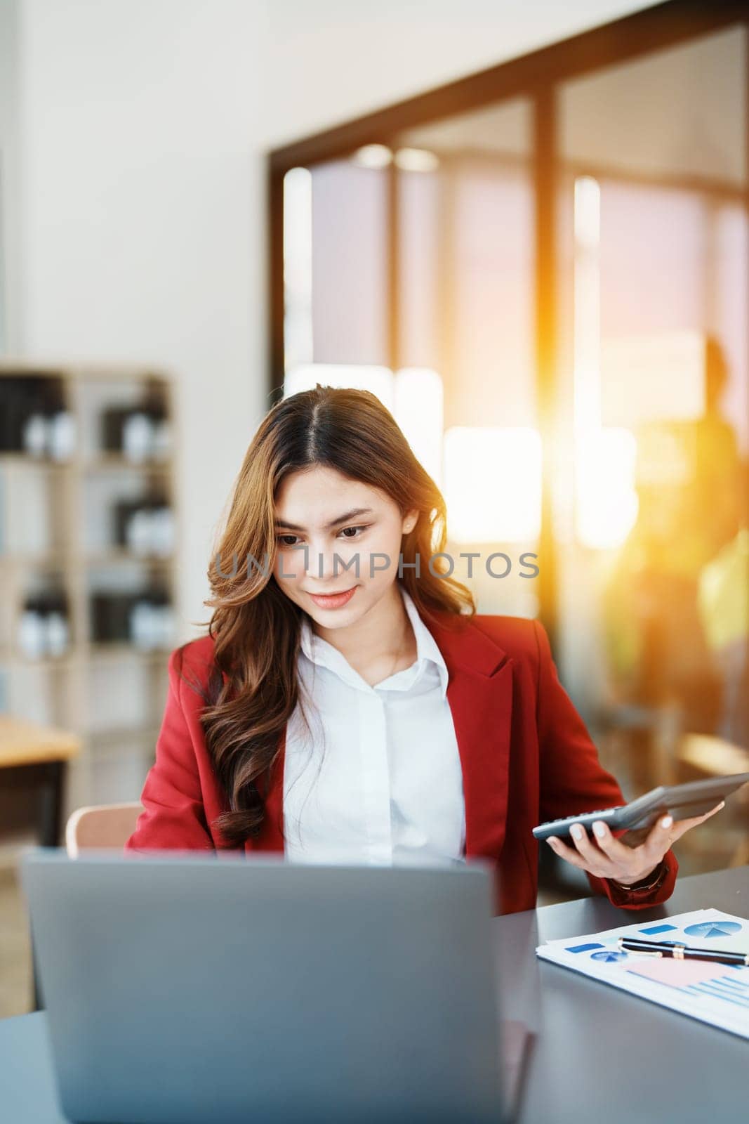 Beautiful young teen asian businesswoman using computer and smartphone mobile with planning working on financial document, tax, exchange, accounting and Financial advisor.
