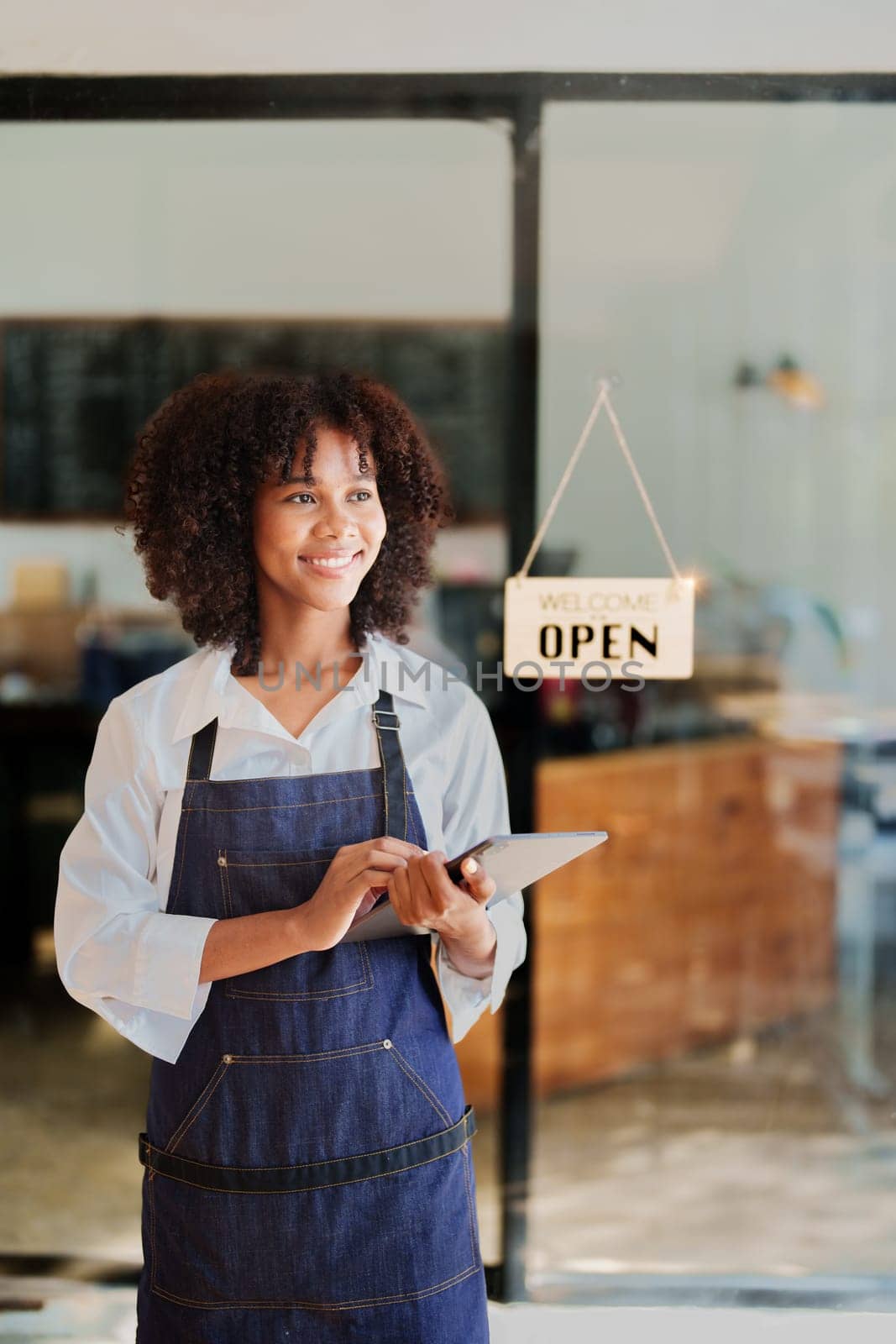 Startup successful small business owner sme beauty girl stand with tablet in coffee shop restaurant, asian tan woman barista cafe owner, entrepreneur seller business concept by Manastrong