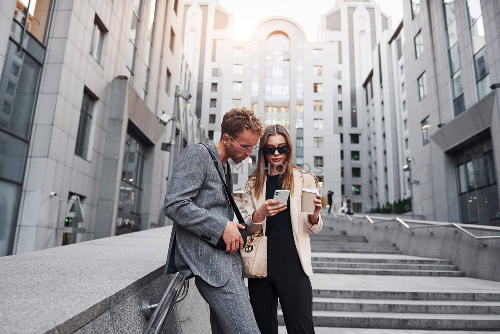 Woman and man in the town at daytime. Well dressed people.