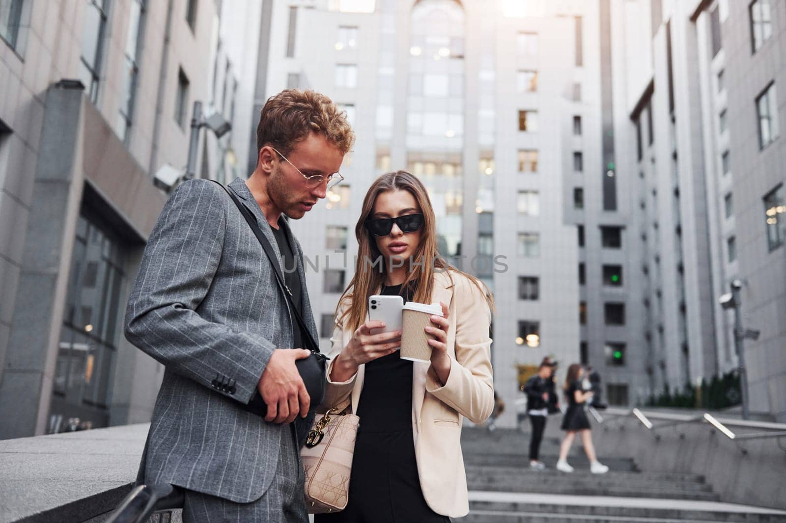 Woman and man in the town at daytime. Well dressed people.