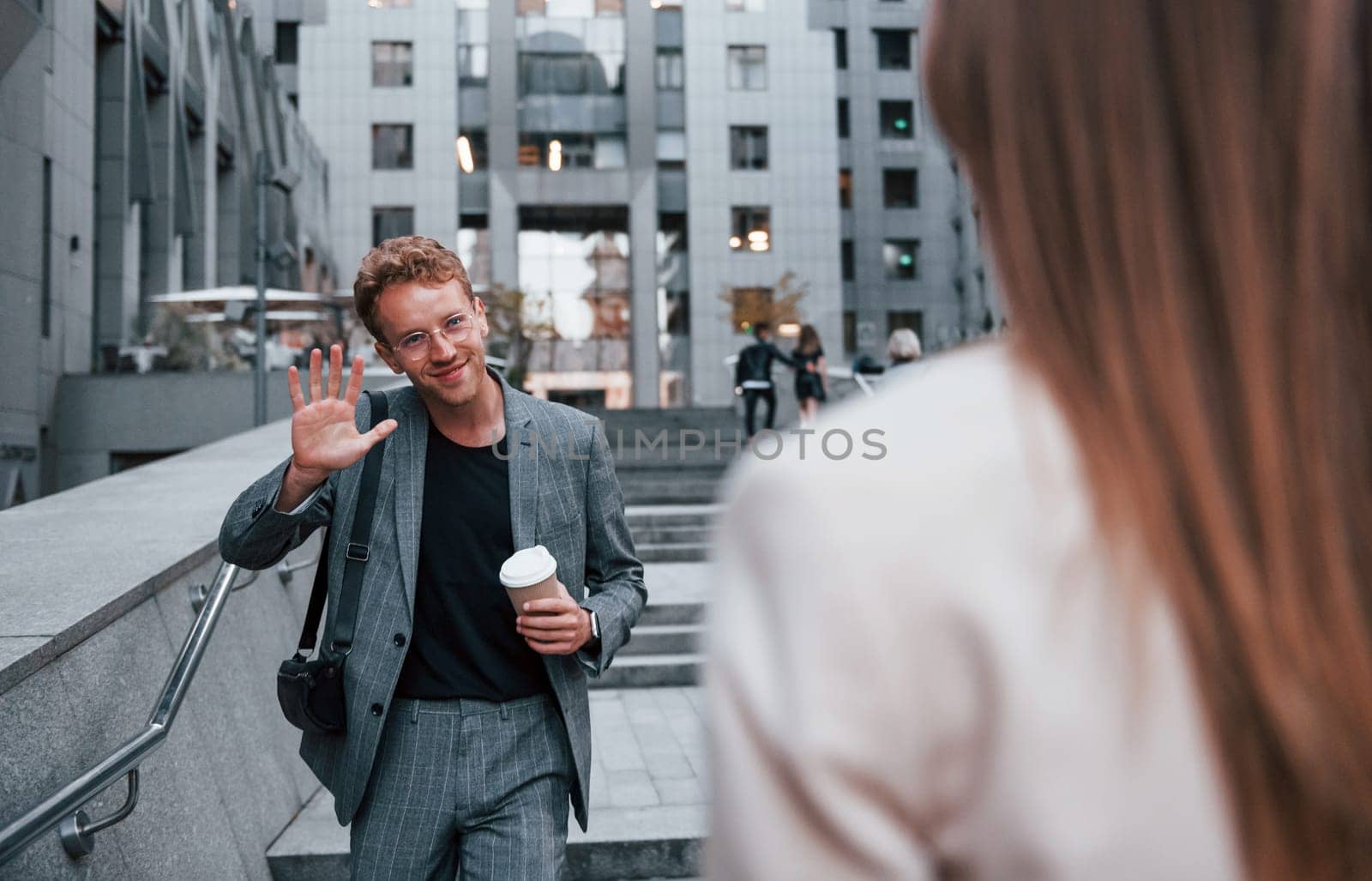 Woman and man in the town at daytime. Well dressed people.