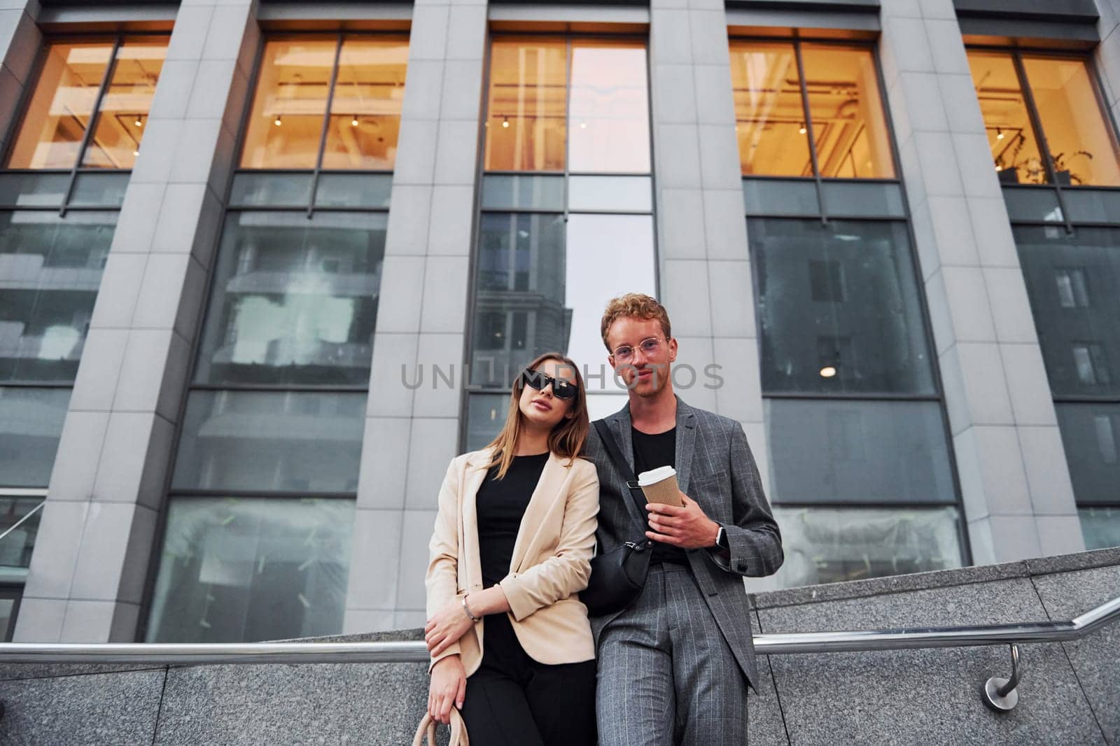 Woman and man in the town at daytime. Well dressed people.