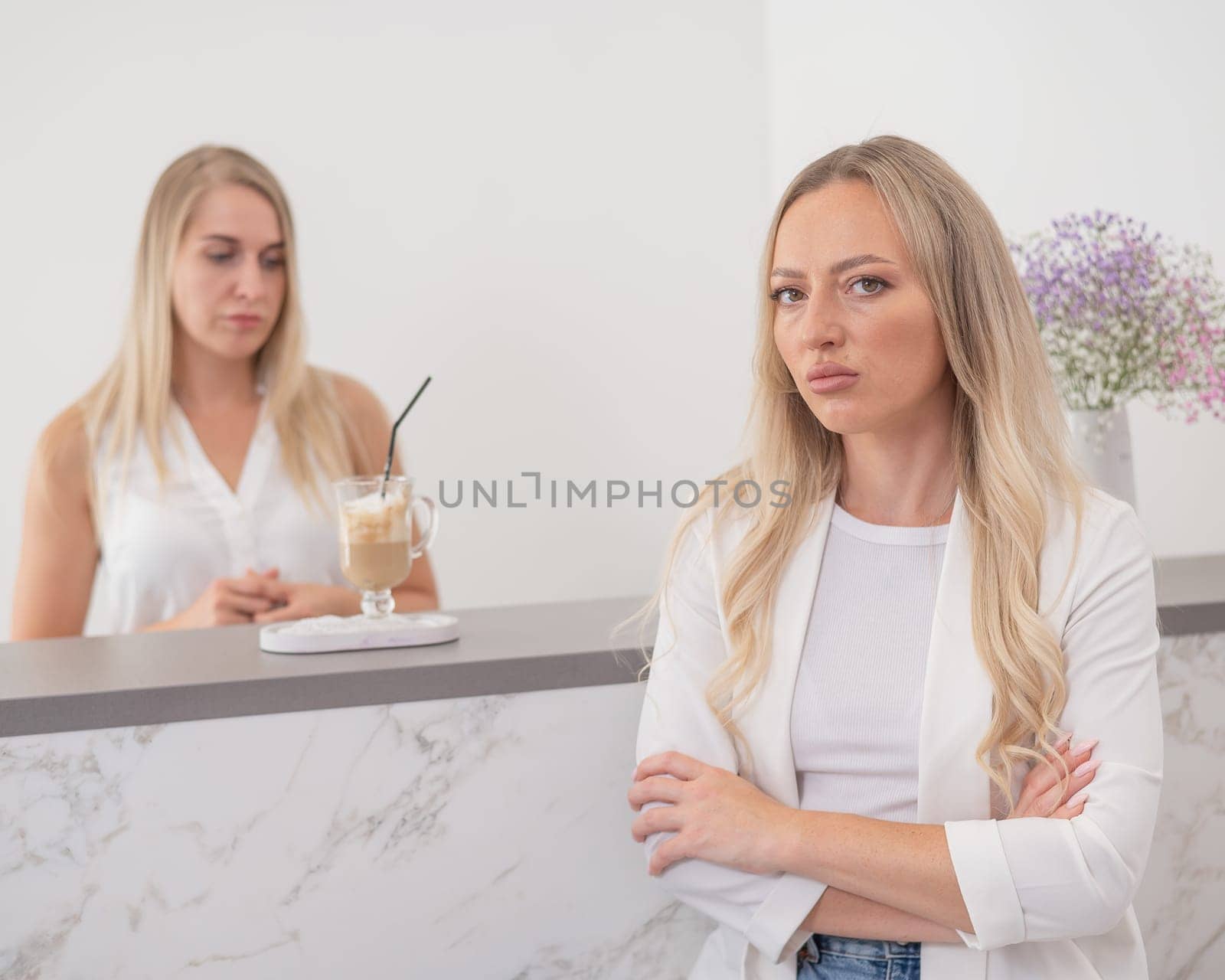 Dissatisfied client stands at the reception of a beauty salon