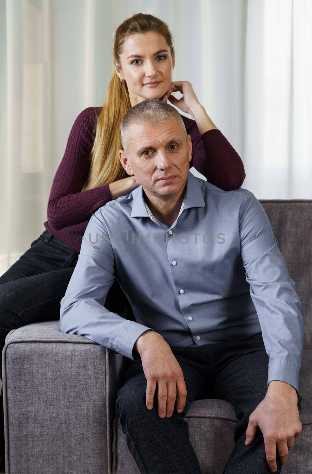 A married couple is sitting on a sofa in an apartment by Sd28DimoN_1976
