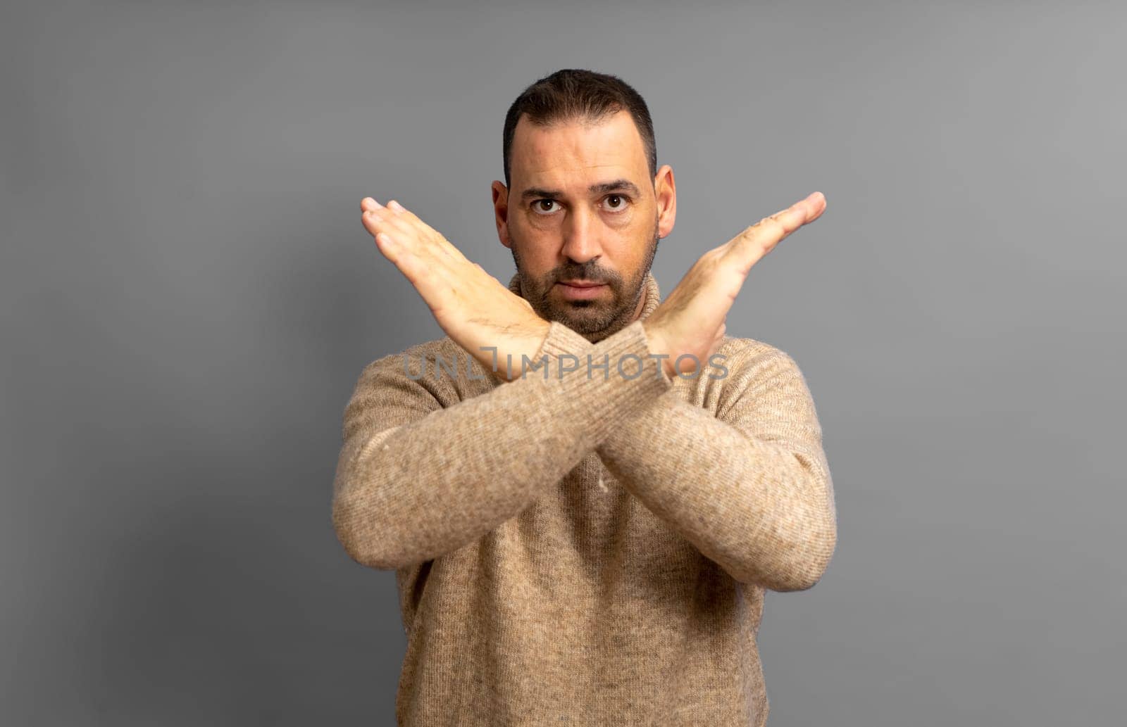 Close up photo amazing him he her middle age male hands palms arms crossed angry straight look won't pass through facial expression isolated on gray background.
