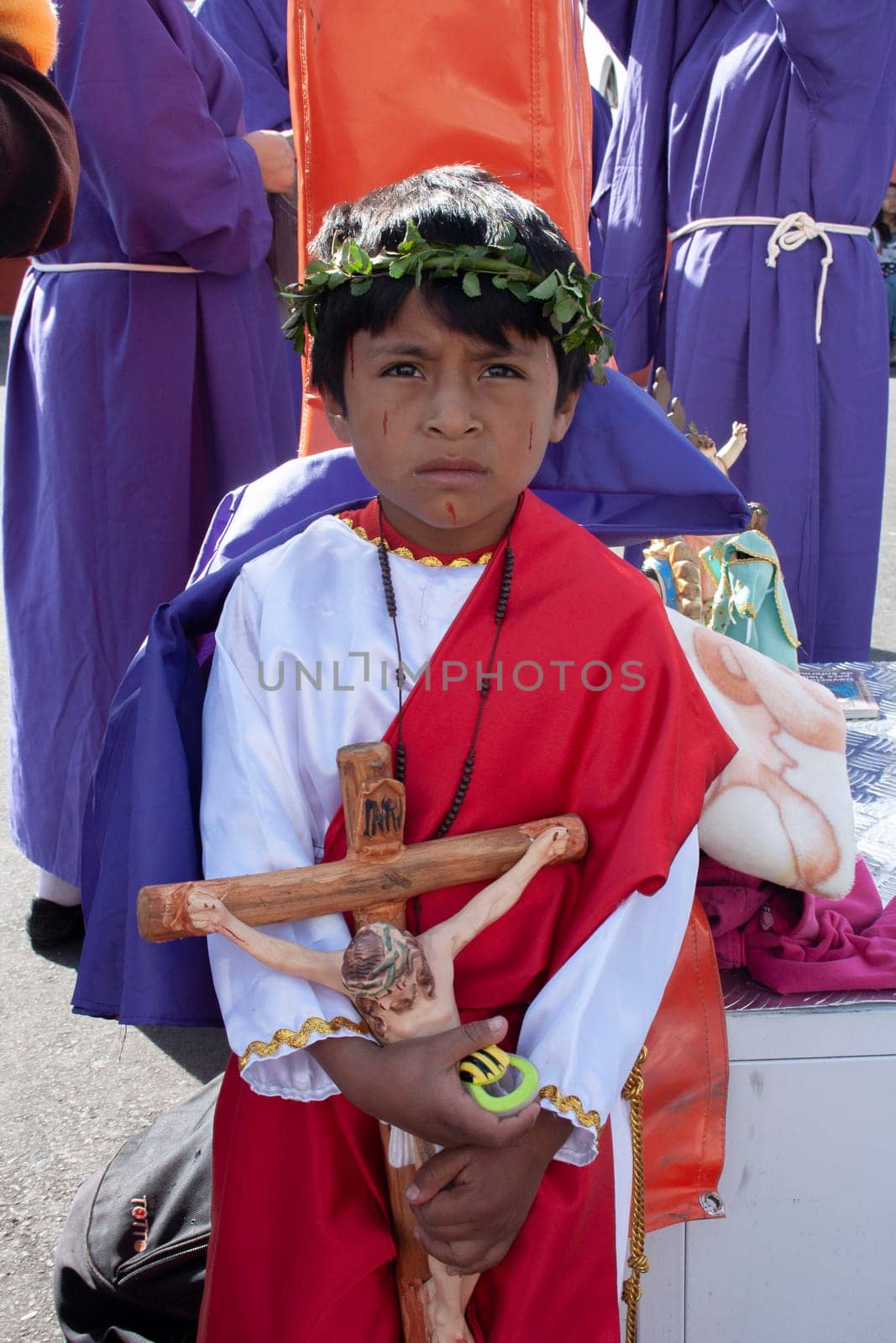 child in holy week procession with the cross of jesus christ in his hands by Raulmartin