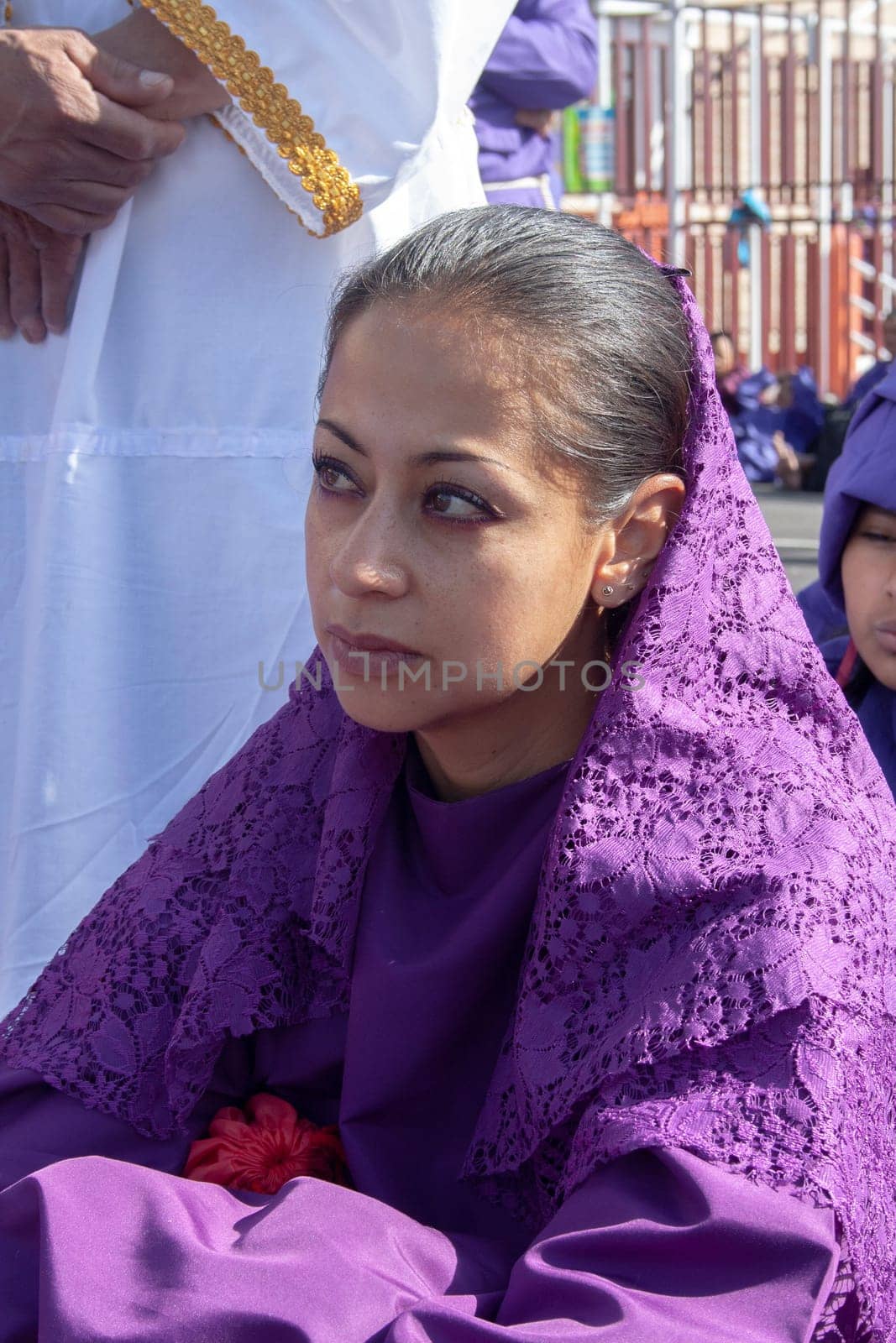 Nazarene woman in a Holy Week procession sitting and tired by Raulmartin